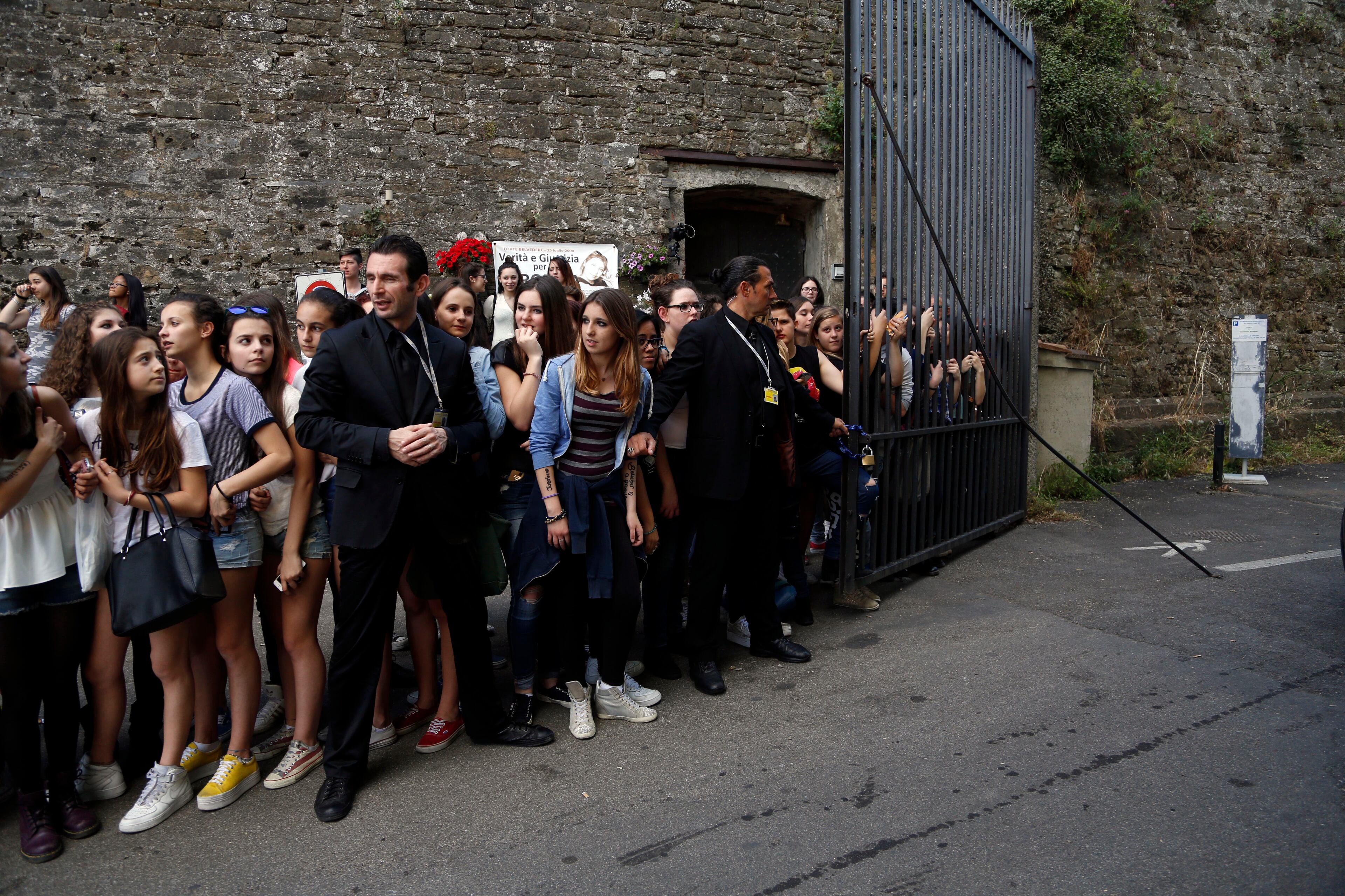 Fans crowd outside Forte Belvedere in Florence, Italy, Saturday, May 24, 2014. Kim Kardashian and Kanye West will wed and host a reception at Florence's imposing 16th-century Belvedere Fort on May 24, according to a spokeswoman at the Florence mayor's office. The couple rented the fort, located next to Florence's famed Boboli Gardens, for 300,000 euros ($410,000) and a Protestant minister will preside over the ceremony. Belvedere Fort was built in 1590, believed using plans by Don Giovanni de' Medici. Located near the Arno River, it offers a panoramic view of Florence and the surrounding Tuscan hills. (AP Photo/Gregorio Borgia)