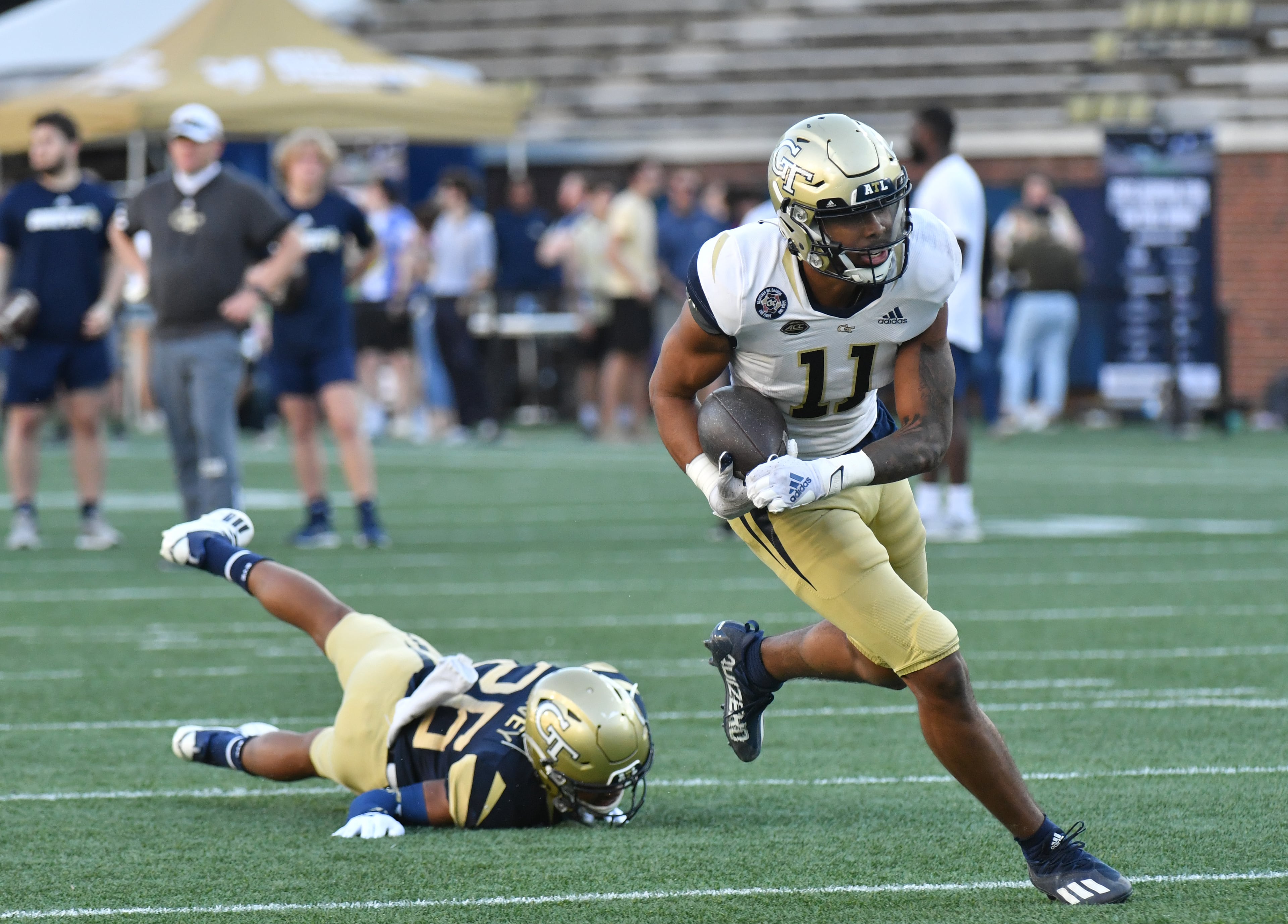 Georgia Tech's wide receiver Ryan King (11) runs past defensive back Ahmari Harvey (26) during the 2022 Spring Game at Georgia Tech's Bobby Dodd Stadium in Atlanta on Thursday, March 17, 2022. (Hyosub Shin / Hyosub.Shin@ajc.com)