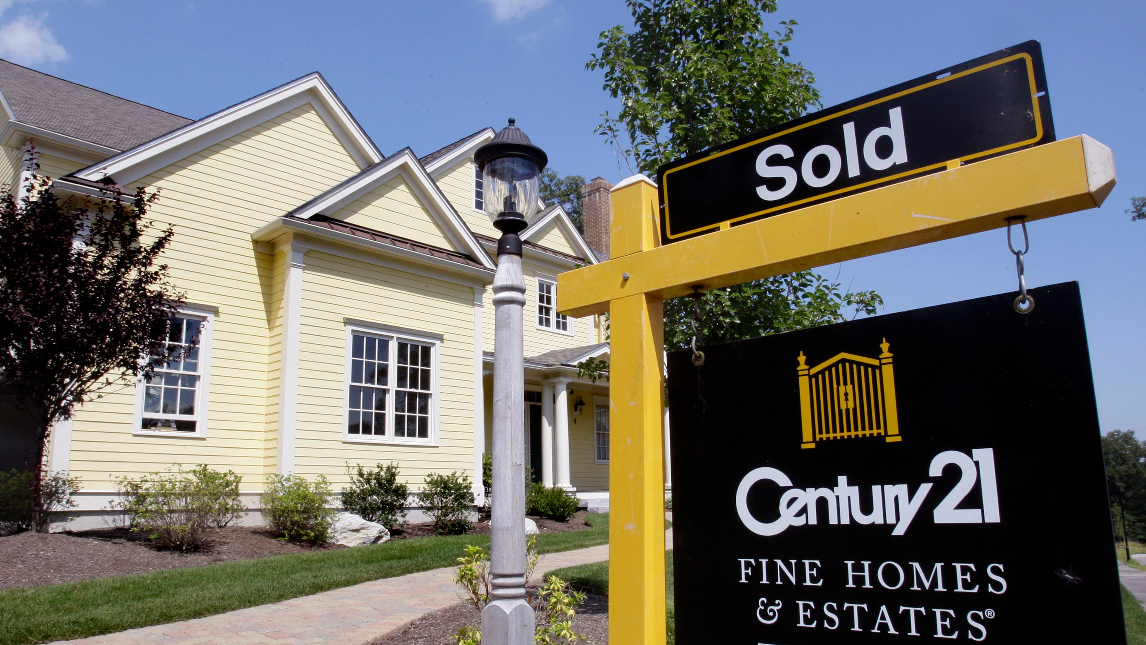 FILE - A sold sign is posted outside a newly constructed luxury home in Wellesley, Mass., Aug. 25, 2009. (AP Photo/Charles Krupa, File)