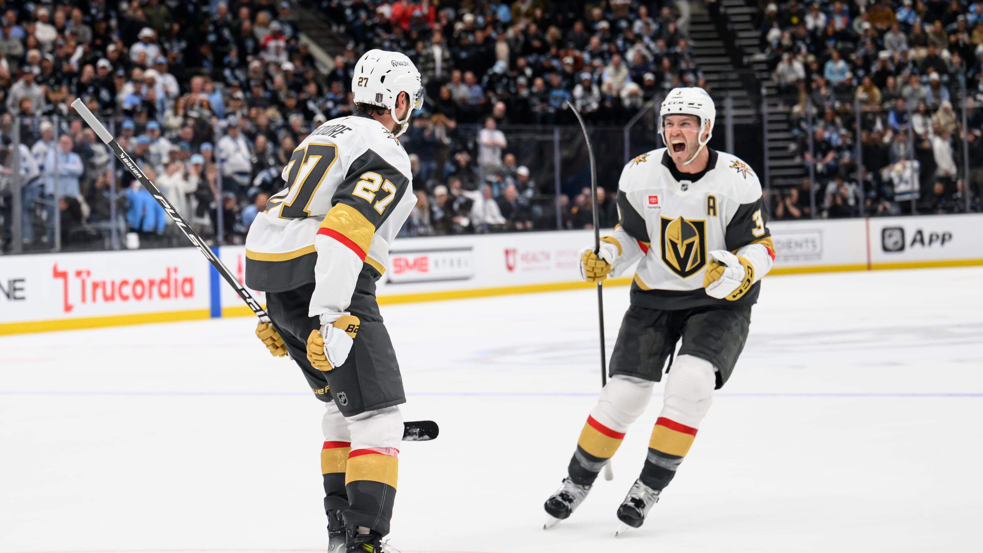 Vegas Golden Knights Brayden McNabb, right, celebrates with Shea Theodore, left, who scored the winning goal during the overtime period of Game 4 of a first-round NHL hockey Stanley Cup playoff series against the Utah Mammoth, Monday, April 27, 2026, in Salt Lake City. (AP Photo/Tyler Tate)