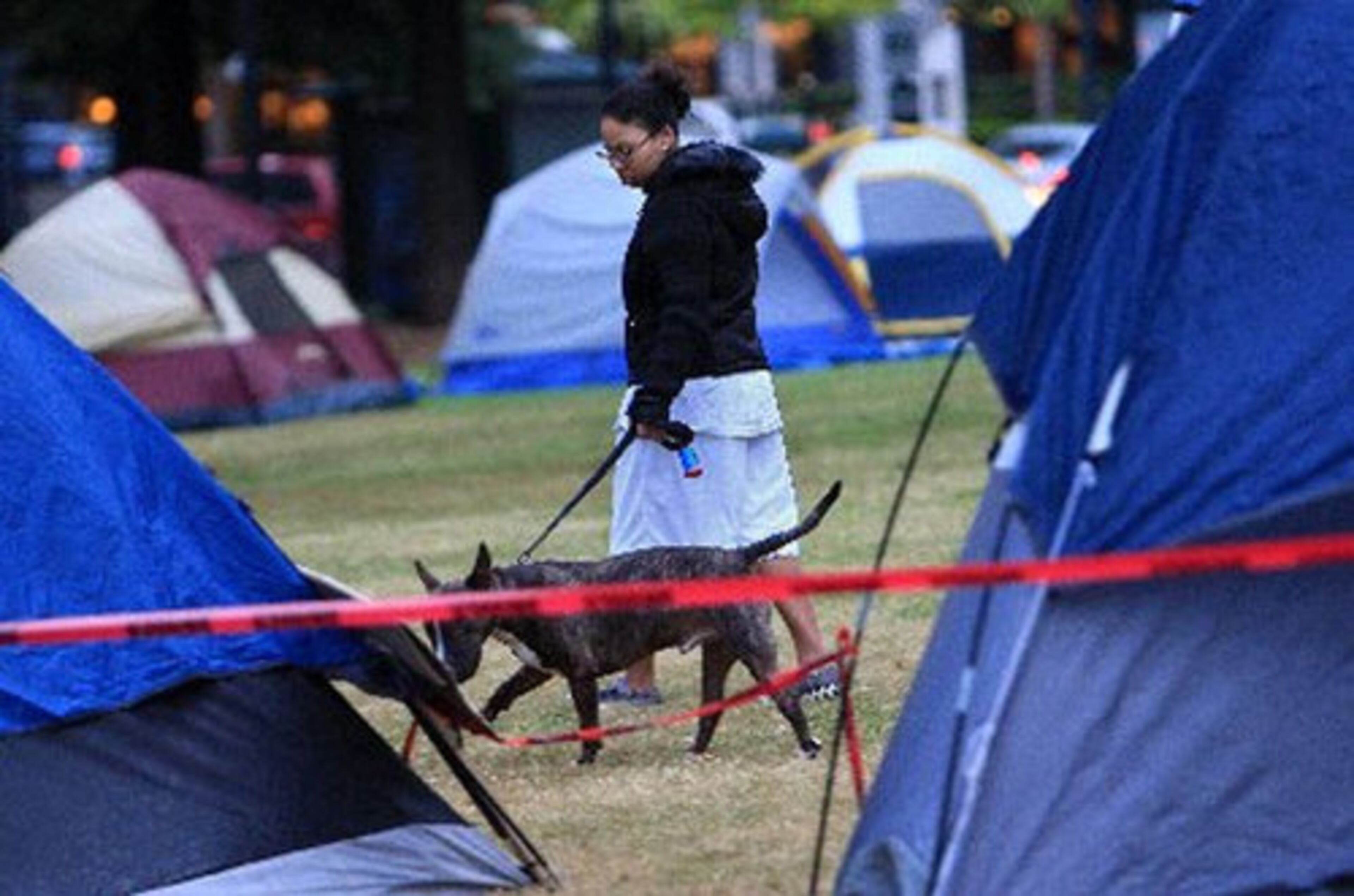 M. Cartwright walks her dog Eli, 3, at the crack of dawn at Woodruff Park on day six as Occupy Atlanta continues its rally. Cartwright who lives across the park, said she didn't mind the campers, but the first few days of the protest was too loud for her comfort.
