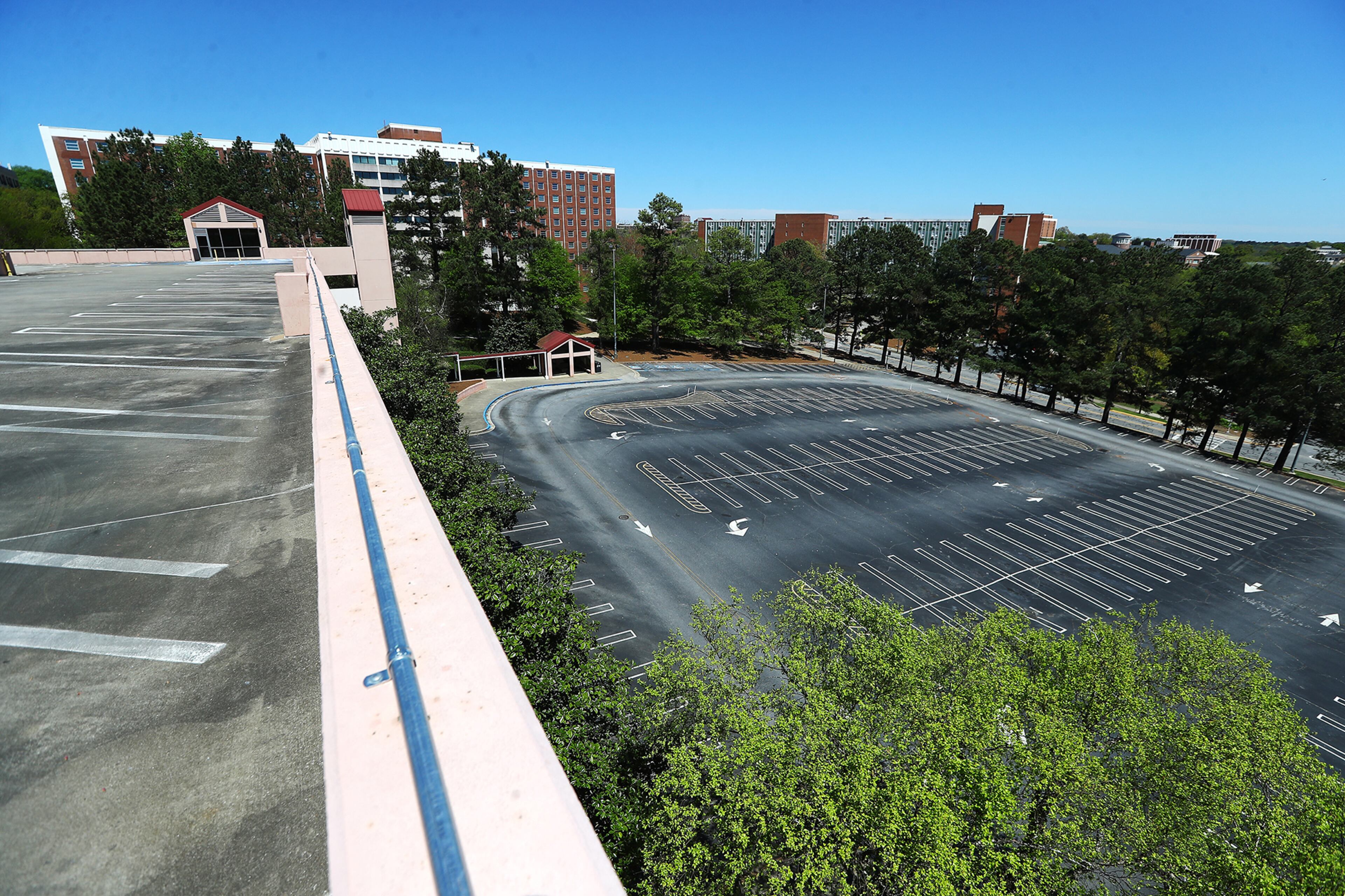 April 2, 2020 Athens: The parking deck and lot is empty outside the student housing building Russell Hall at the University of Georgia on Thursday, April 2, 2020, in Athens. Curtis Compton ccompton@ajc.com