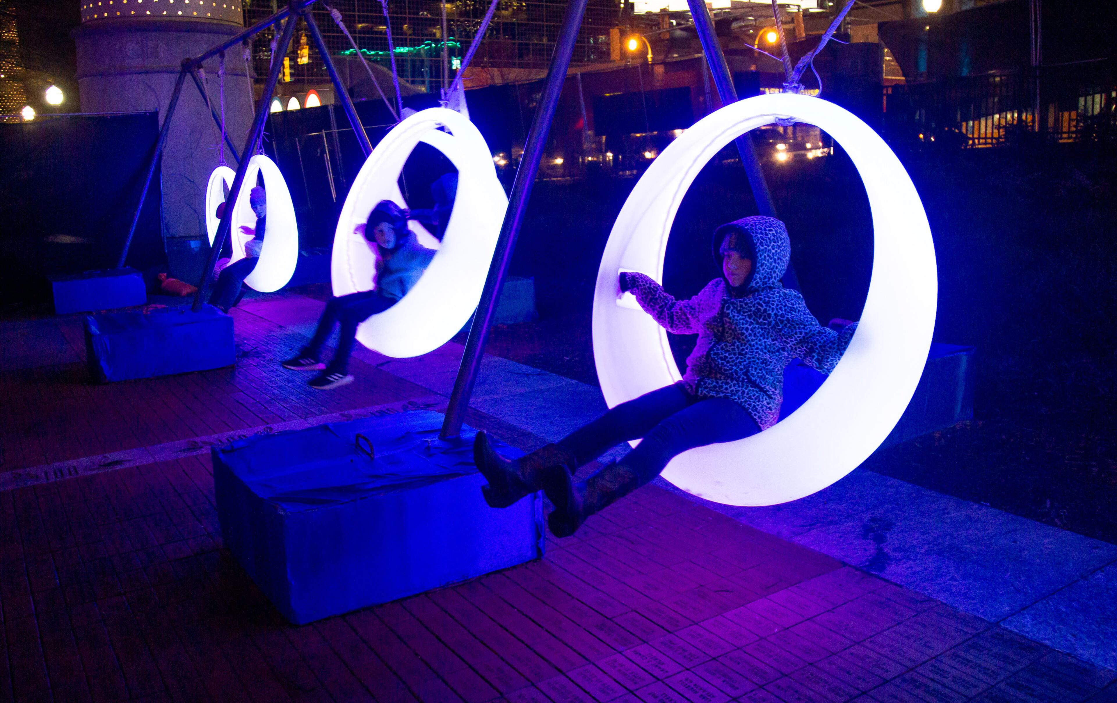 Fairgoers swing on the Moon Swing during the Chinese Lantern Festival at Centennial Olympic Park Saturday, January 04, 2020.. STEVE SCHAEFER / SPECIAL TO THE AJC