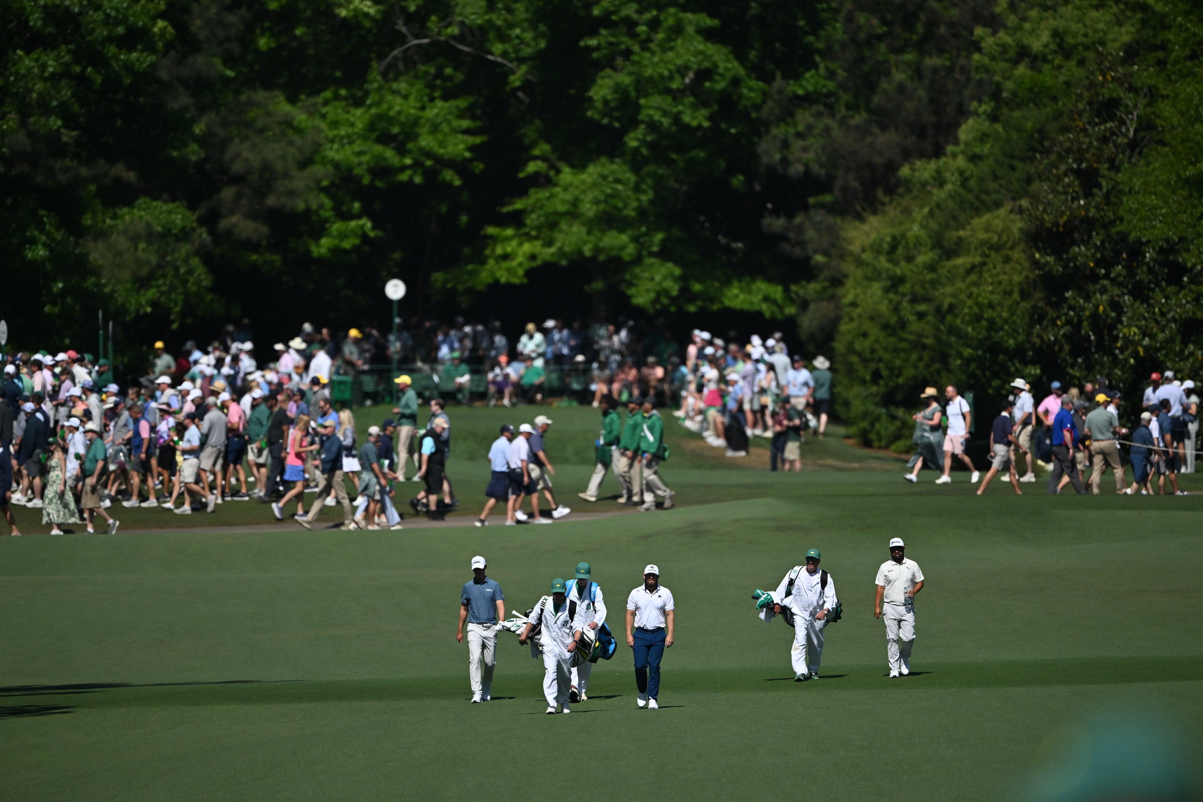 Tyrrell Hatton, J.J. Spaun, Maverick McNealy and their caddies walk up the seventh fairway during the second round of the Masters at Augusta National on Friday, April 10, 2026 in Augusta, Ga. (Hyosub Shin/AJC)