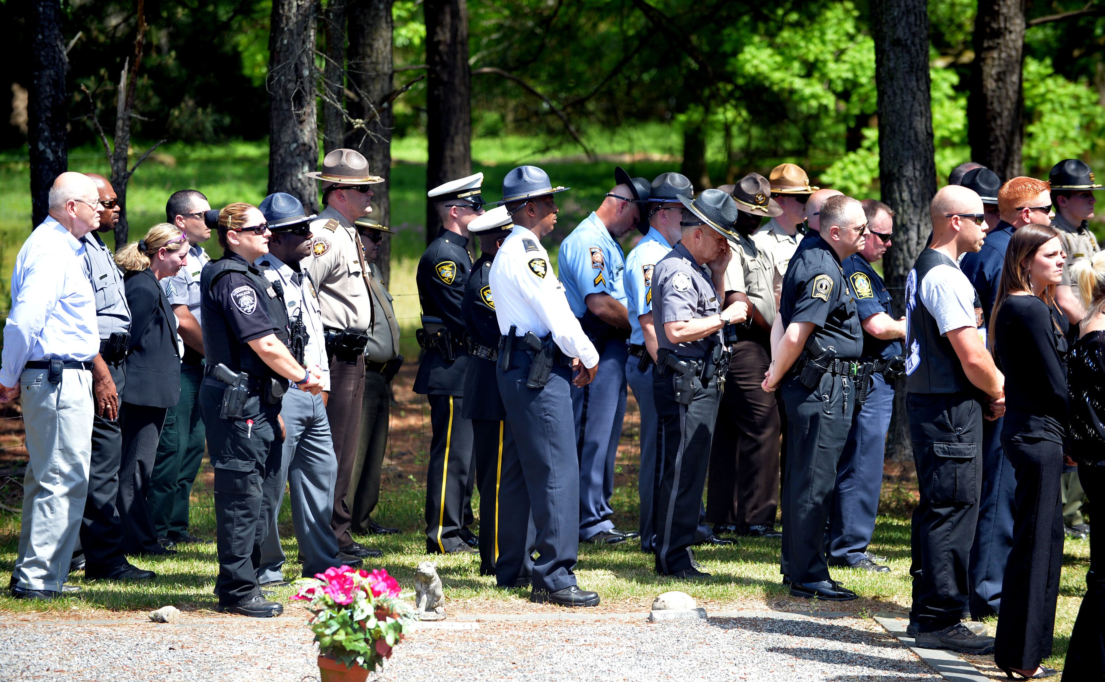 Family members, friends and officers from several law enforcement agencies attend funeral services for Eatonton police officer Noel Lee Hawk, 52, of Madison, at the A. E. Carter Funeral home chapel on Wednesday, May, 7, 2014. Officer Hawk died from a heart attack shortly after breaking up a fight at an Eatonton fast-food restaurant on May 4.