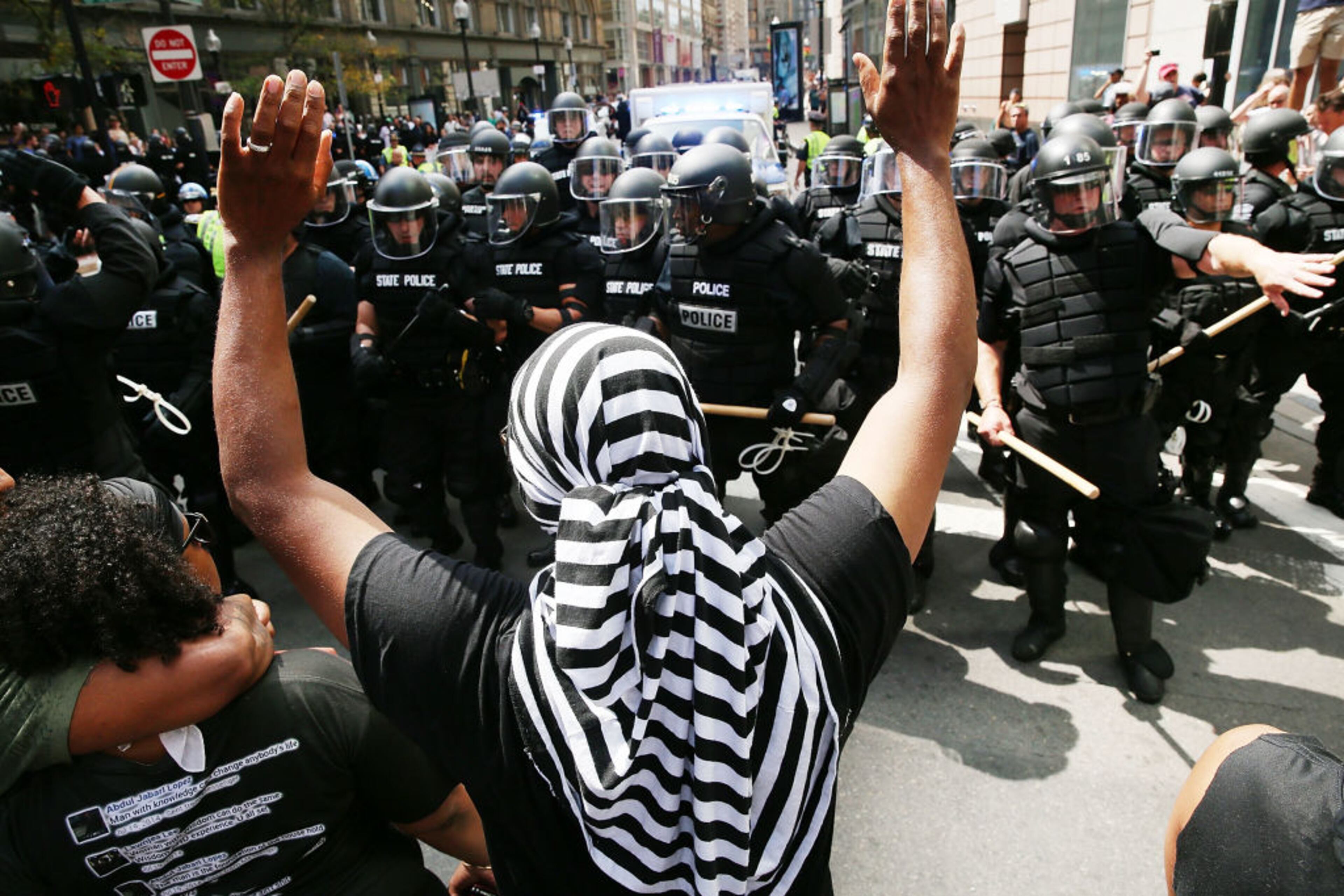BOSTON, MA - AUGUST 19: Protesters face off with riot police escorting conservative activists following a march in Boston against a planned 'Free Speech Rally' just one week after the violent 'Unite the Right' rally in Virginia left one woman dead and dozens more injured on August 19, 2017 in Boston, United States. Although the rally organizers stress that they are not associated with any alt-right or white supremacist groups, the city of Boston and Police Commissioner William Evans are preparing for possible confrontations at the afternoon rally. (Photo by Spencer Platt/Getty Images)