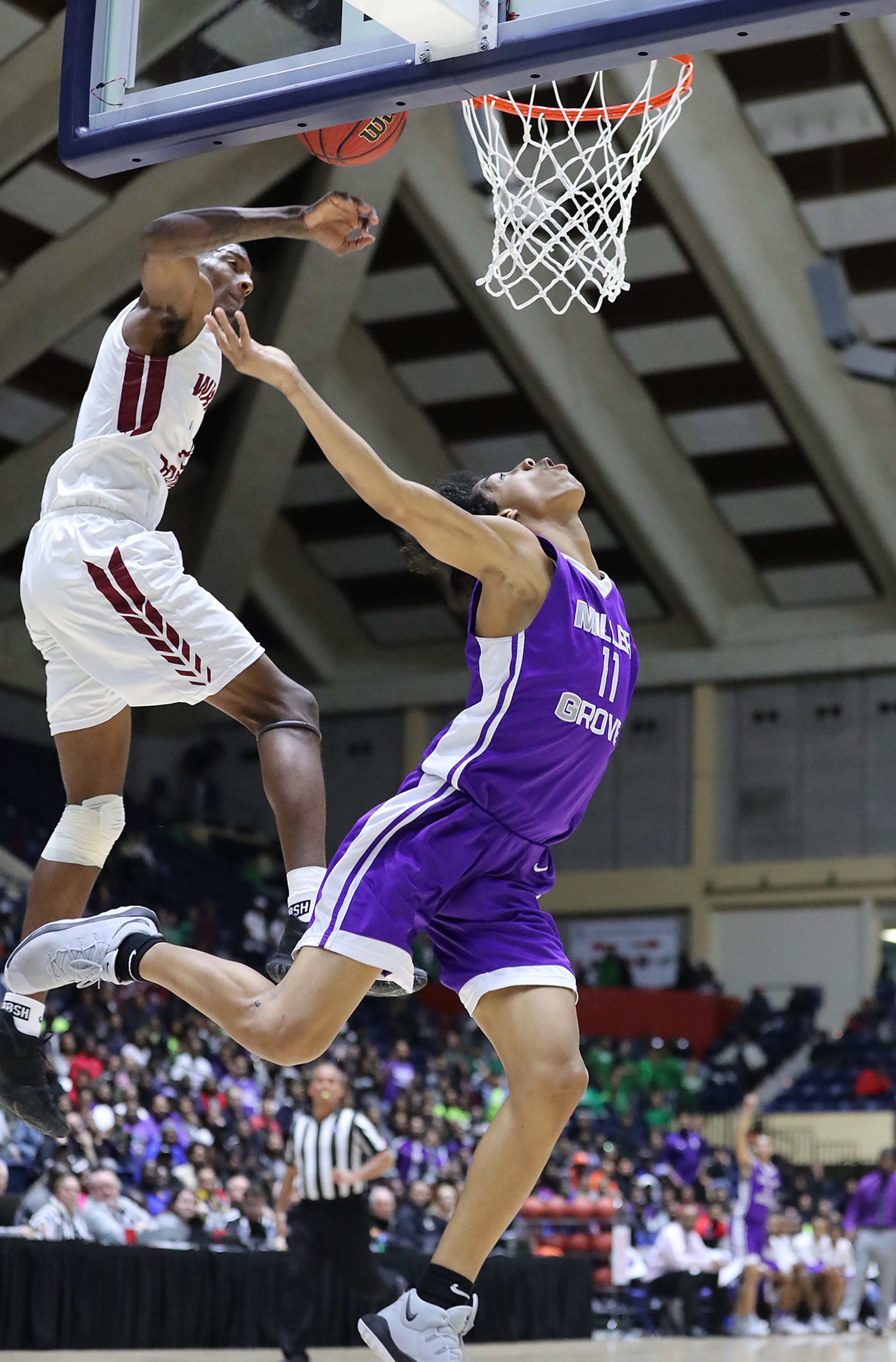 March 8, 2018 Macon: Miller Grove guard Terrence Edwards has his shot blocked by Warner Robins defender Nelson Phillips in their GHSA state basketball championship game on Thursday, March 8, 2018, in Macon. Curtis Compton/ccompton@ajc.com