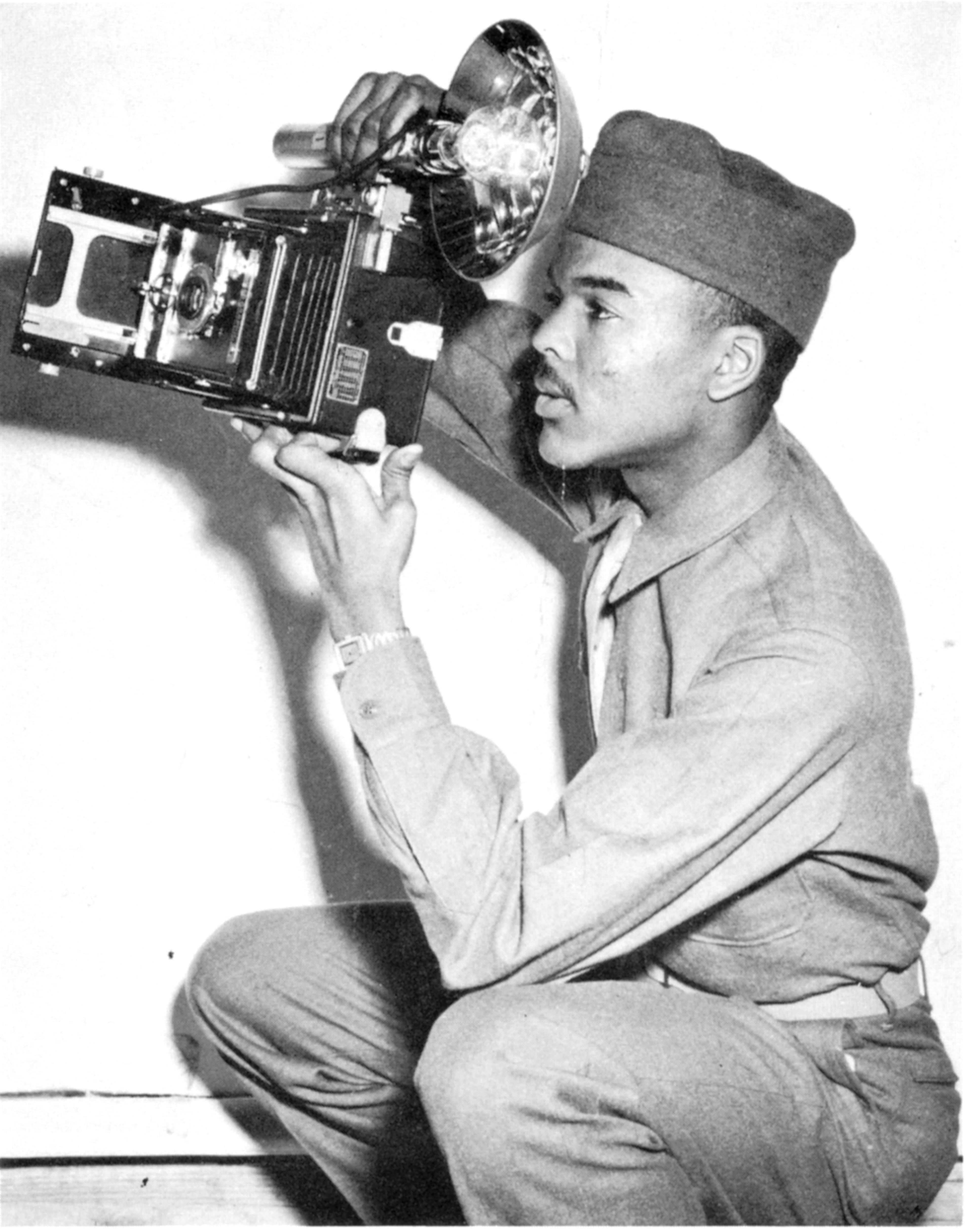 A young W.A. Scott III honed his photography skills in the U.S. Army during World War II. In 1945, Scott was assigned to shoot photographs of a liberated concentration camp, Buchenwald. He only snapped a few pictures before putting his camera away. "As the scenes became more gruesome, I put my camera in its case and walked in a daze with the survivors as we viewed all forms of dismemberment of the human body," Scott wrote upon his return.