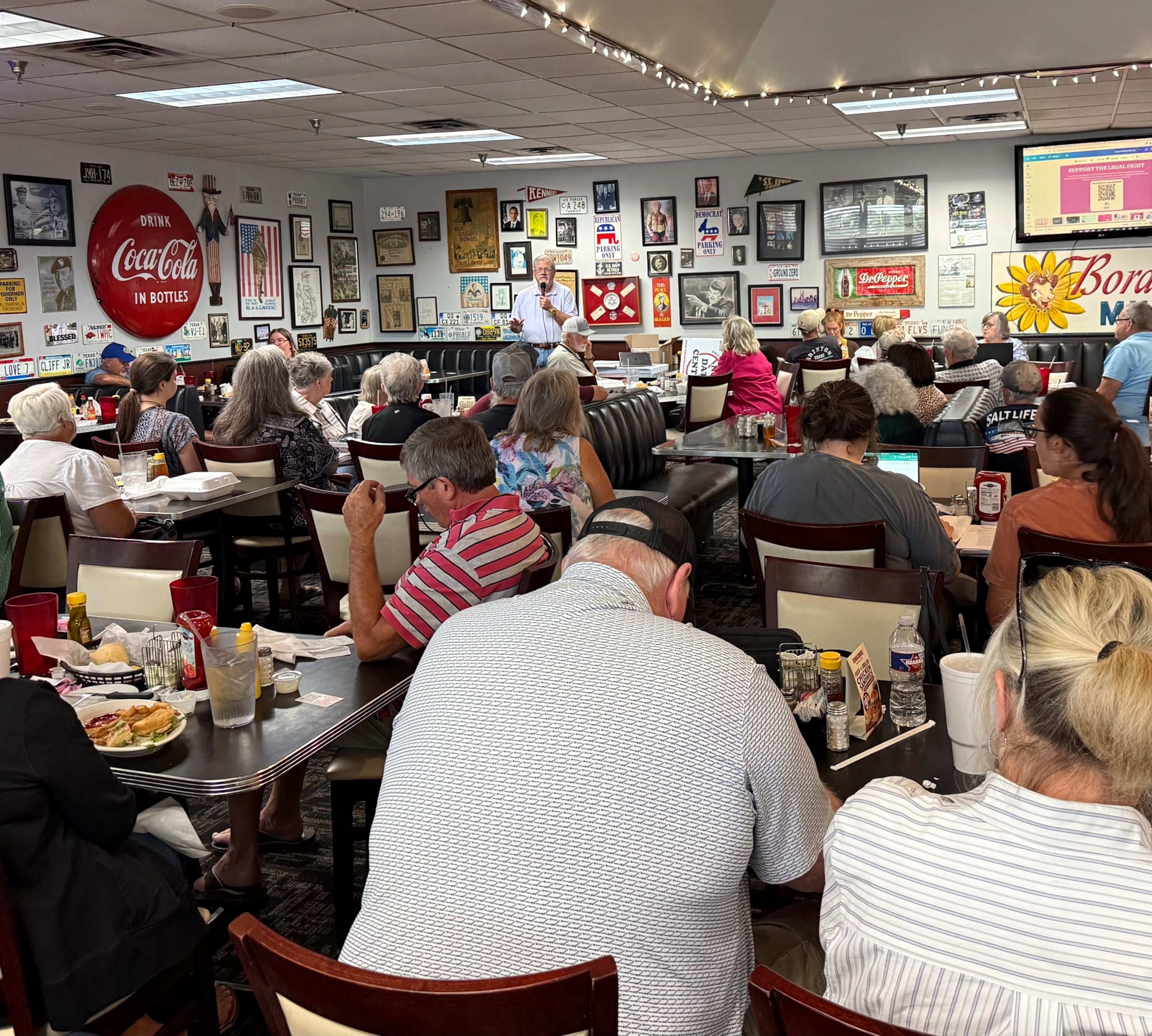 A crowd at the Dixie Diner in Texarkana, Texas, listen as Danny Proctor updates them on the development of controversial data center projects in the community on Thursday. Proctor has led the community's fight against the proposals, including one from a firm linked to Georgia Republican nominee for governor Rick Jackson. (Greg Bluestein/AJC)