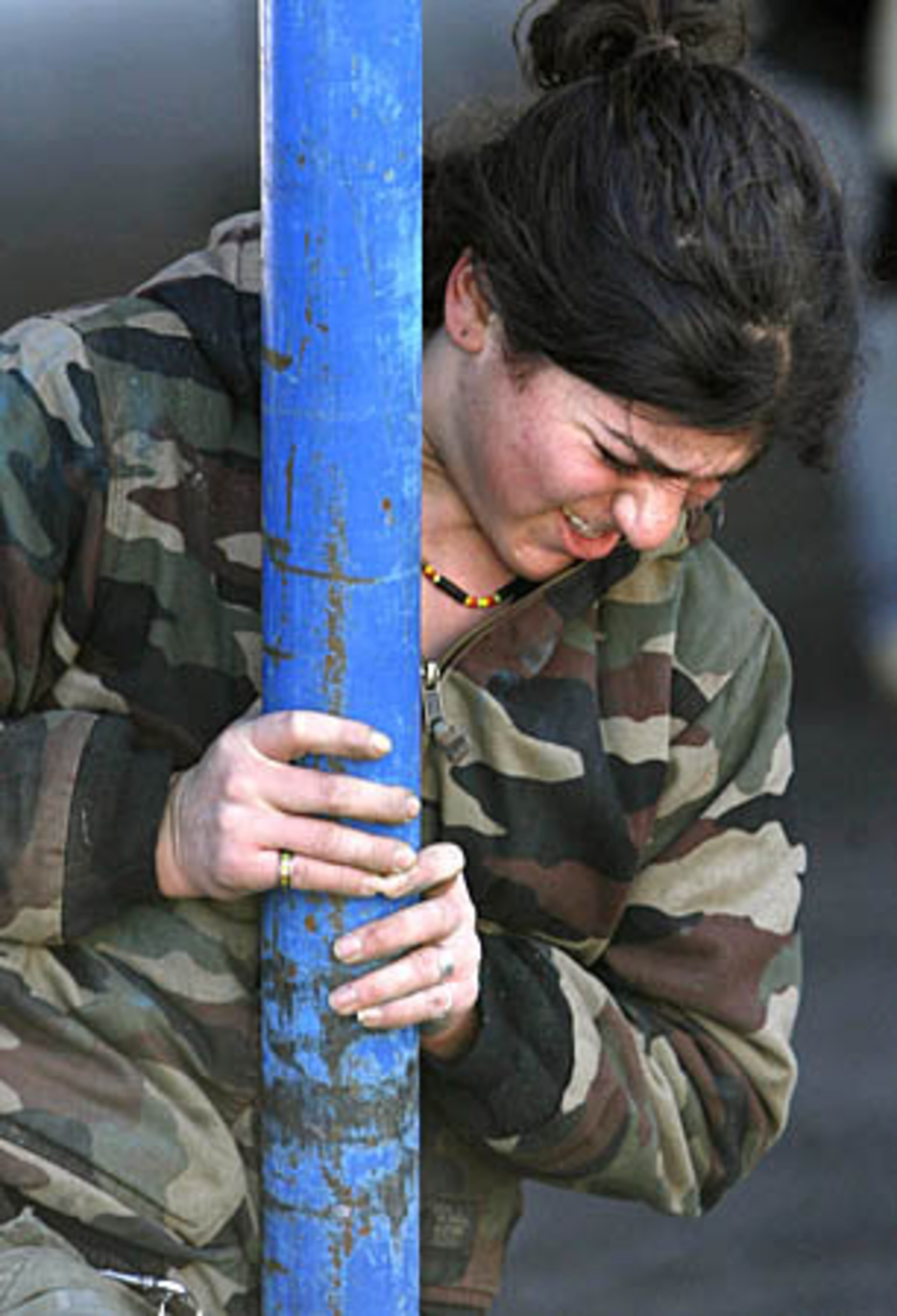 Crew member Tara Dragani puts all her energy into pushing a pole during the tent raising.