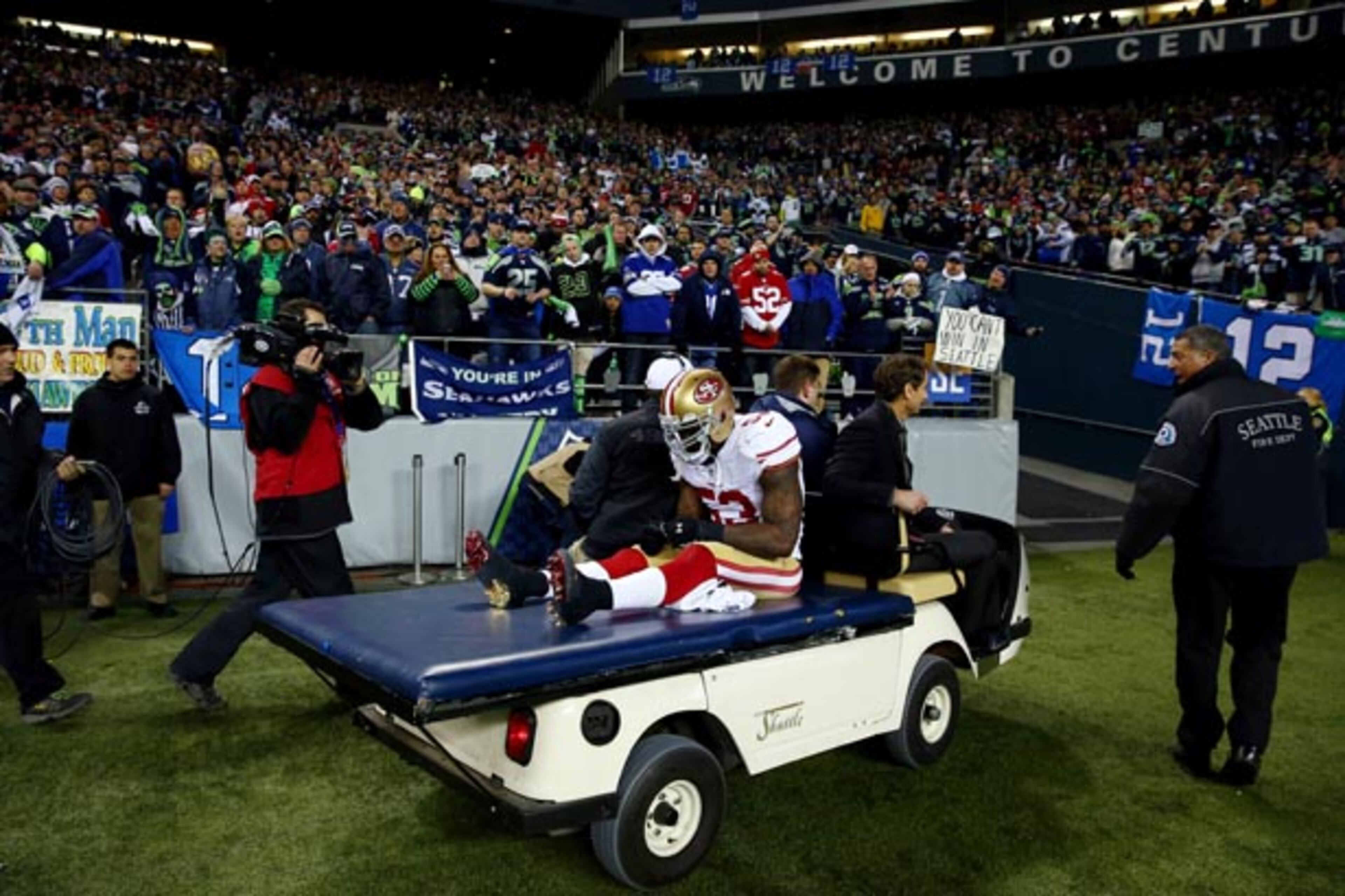 SEATTLE, WA - JANUARY 19: Linebacker NaVorro Bowman #53 of the San Francisco 49ers is carted off the field in the fourth quarter against the Seattle Seahawks during the 2014 NFC Championship at CenturyLink Field on January 19, 2014 in Seattle, Washington. (Photo by Tom Pennington/Getty Images)