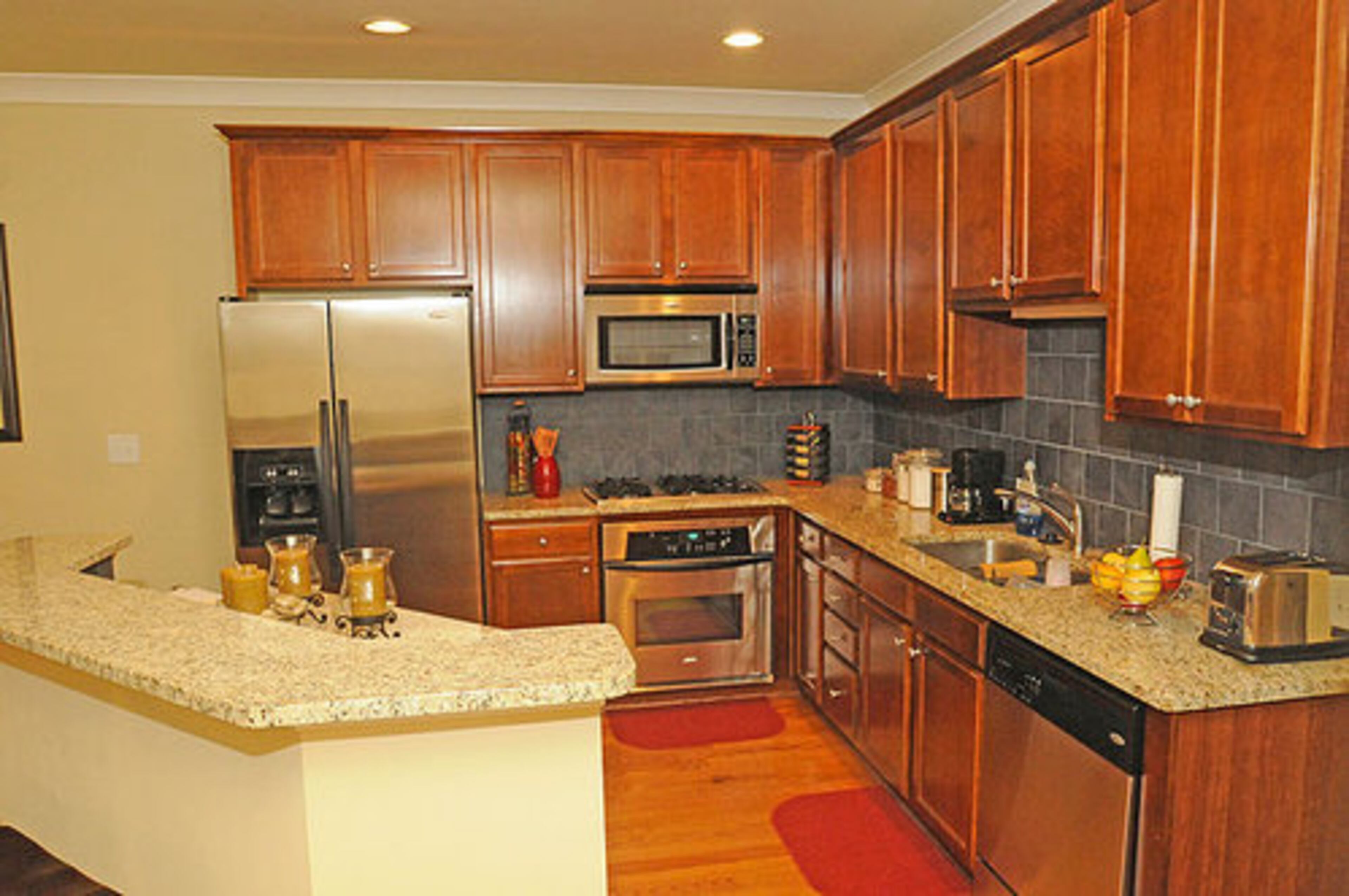 The kitchen features granite countertops and stainless steel appliances in the kitchen.