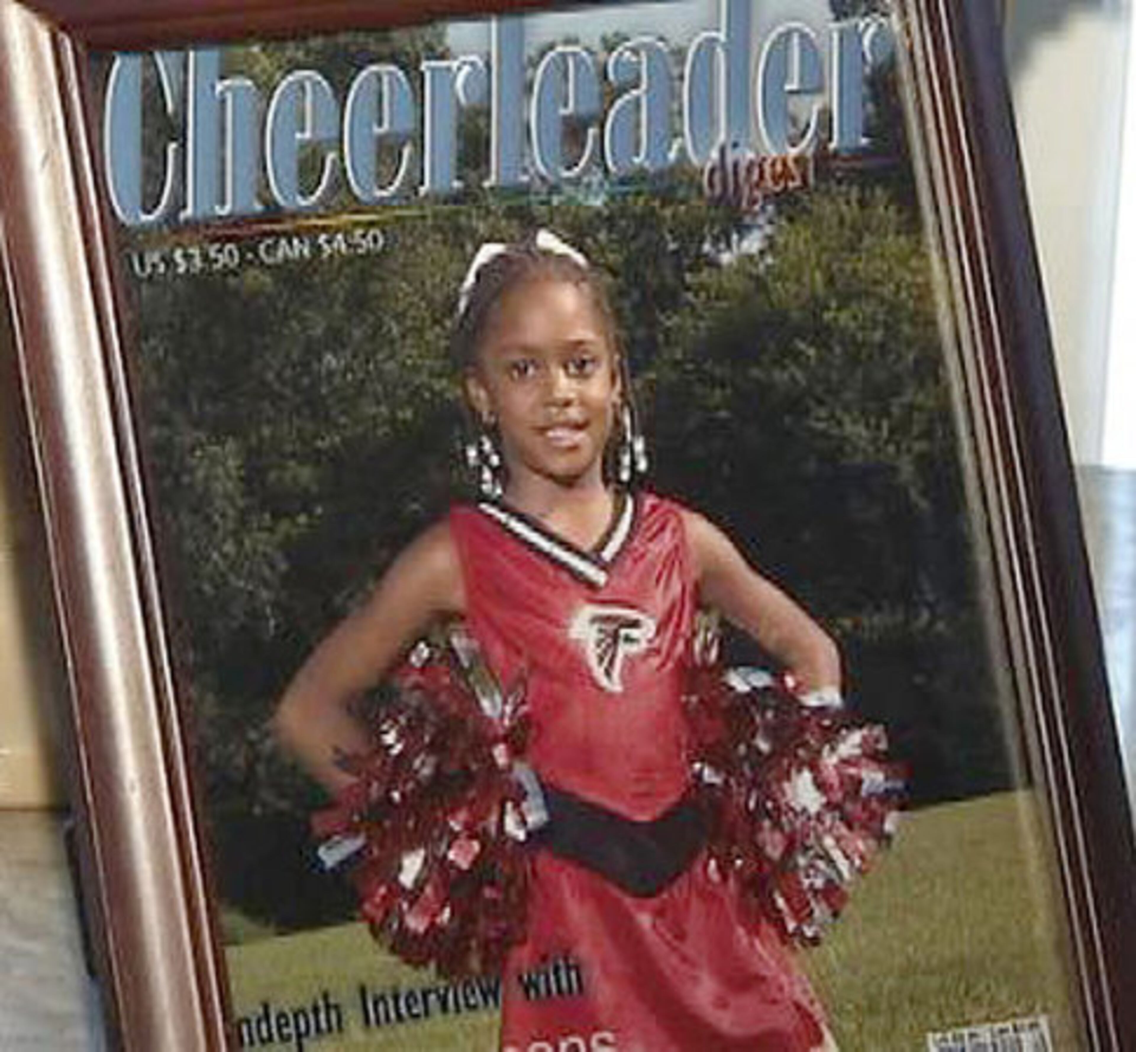 Delisia Carter's daughter, Kayla, in a family photo on the cover of a cheerleading magazine.