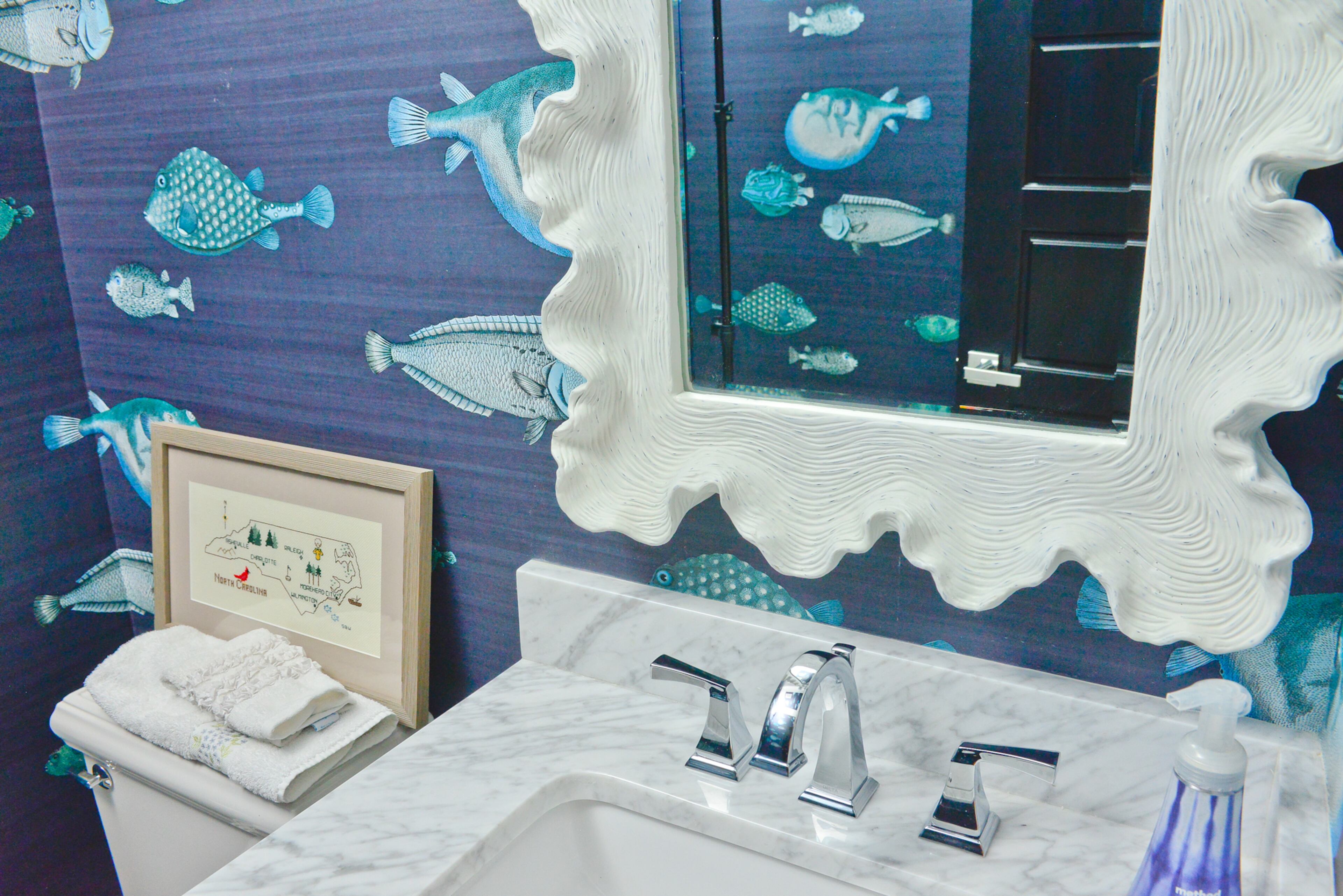 The homeowner grew up on the coast in Morehead City, North Carolina. White wanted to bring a bit of the sea to the Old Fourth Ward home, which was featured on the 2016 Fall in the Fourth Tour of Homes in September. In her half-bathroom, this brilliant fish wallpaper by Cole & Son goes swimmingly with the shell-like frame on the mirror.
