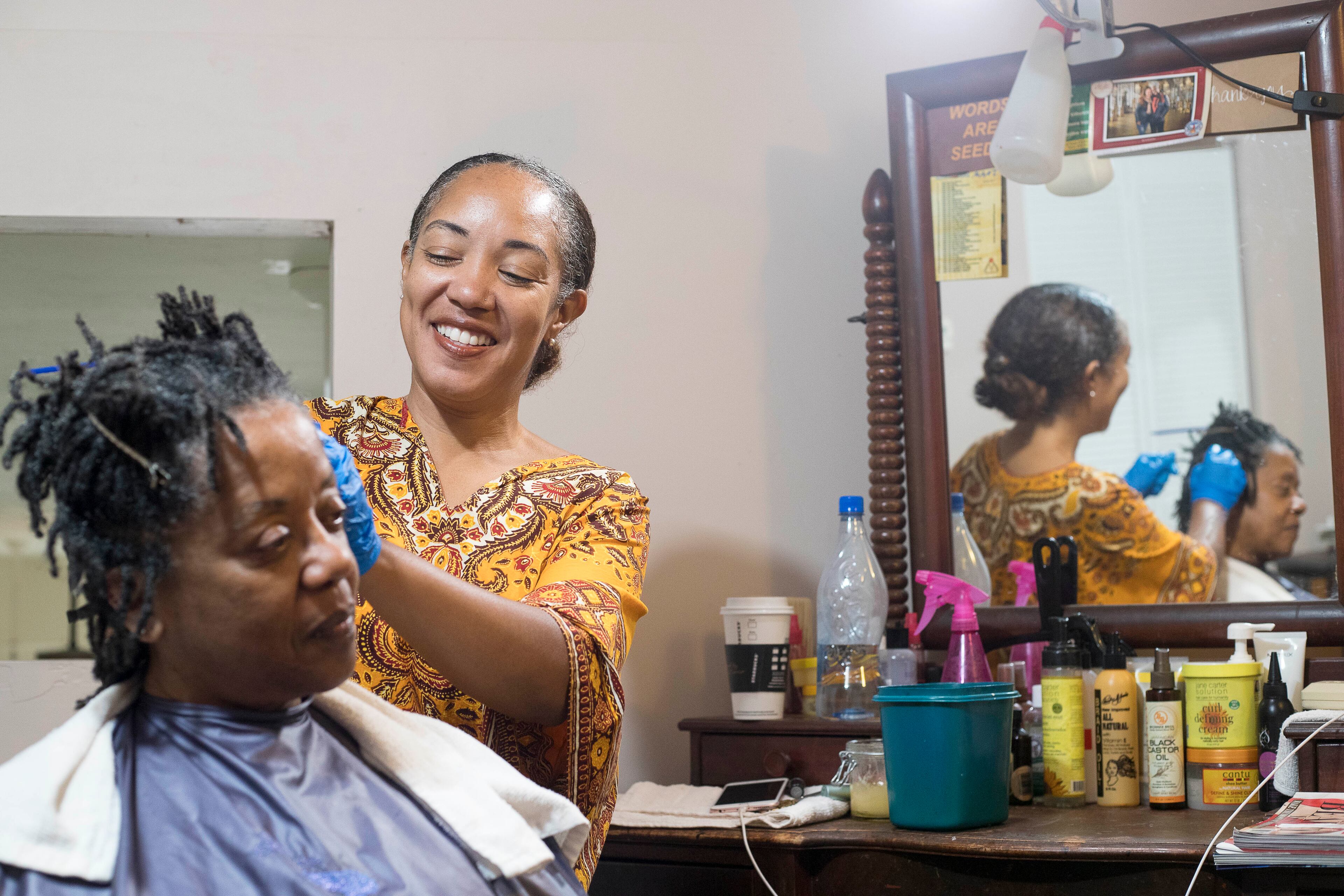 09/07/2018 -- Atlanta, Georgia -- Hairstylist Erica Blevins (right) retwists Gwendolyn Pilot's Locs at the Oh! My Nappy Hair salon in downtown Atlanta, Friday, September 7, 2018. (ALYSSA POINTER/ALYSSA.POINTER@AJC.COM)