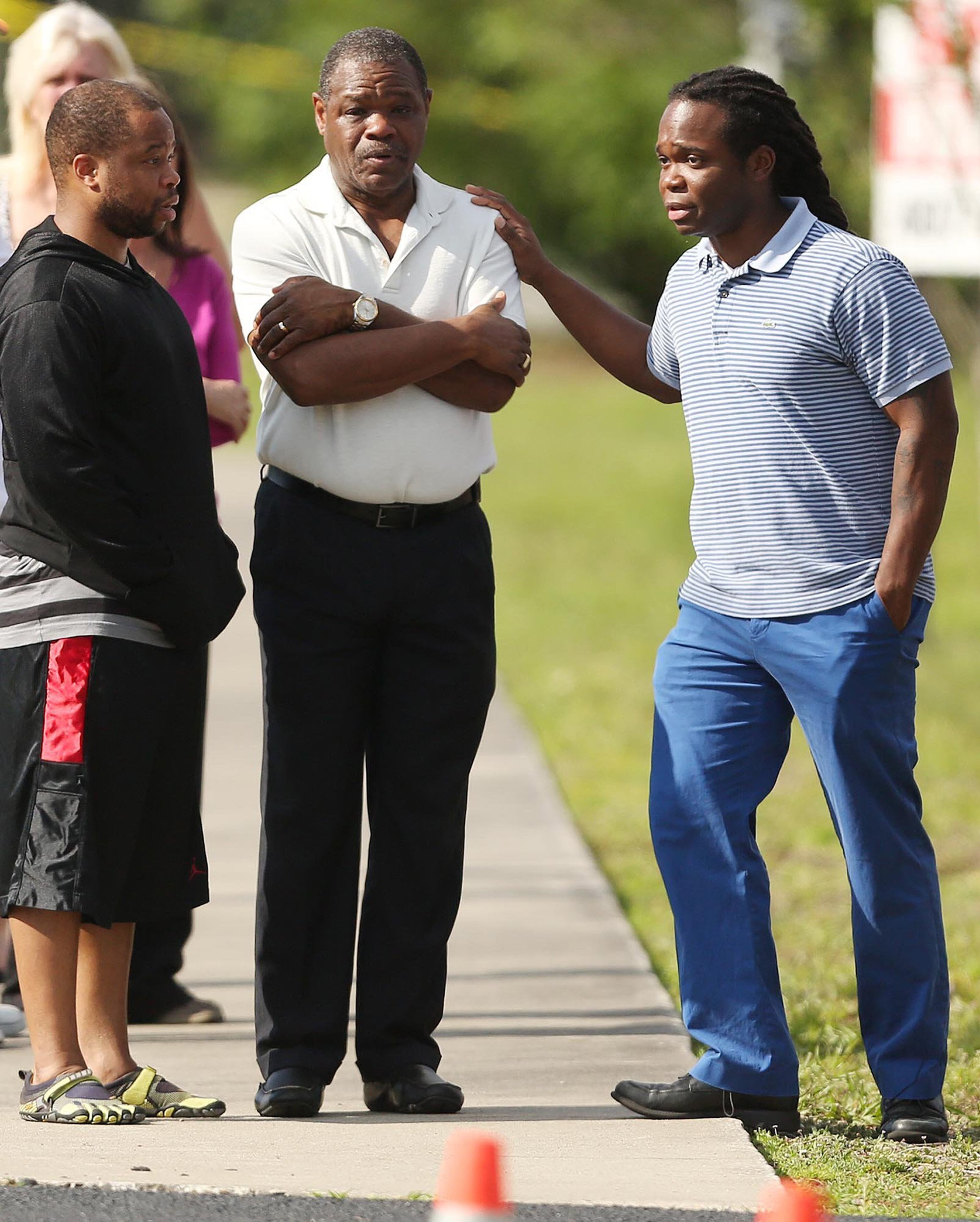 People console one another outside the KinderCare Learning Center in Winter Park, Fla., Wednesday, April 9, 2014. (Stephen M. Dowell, Orlando Sentinel/MCT)