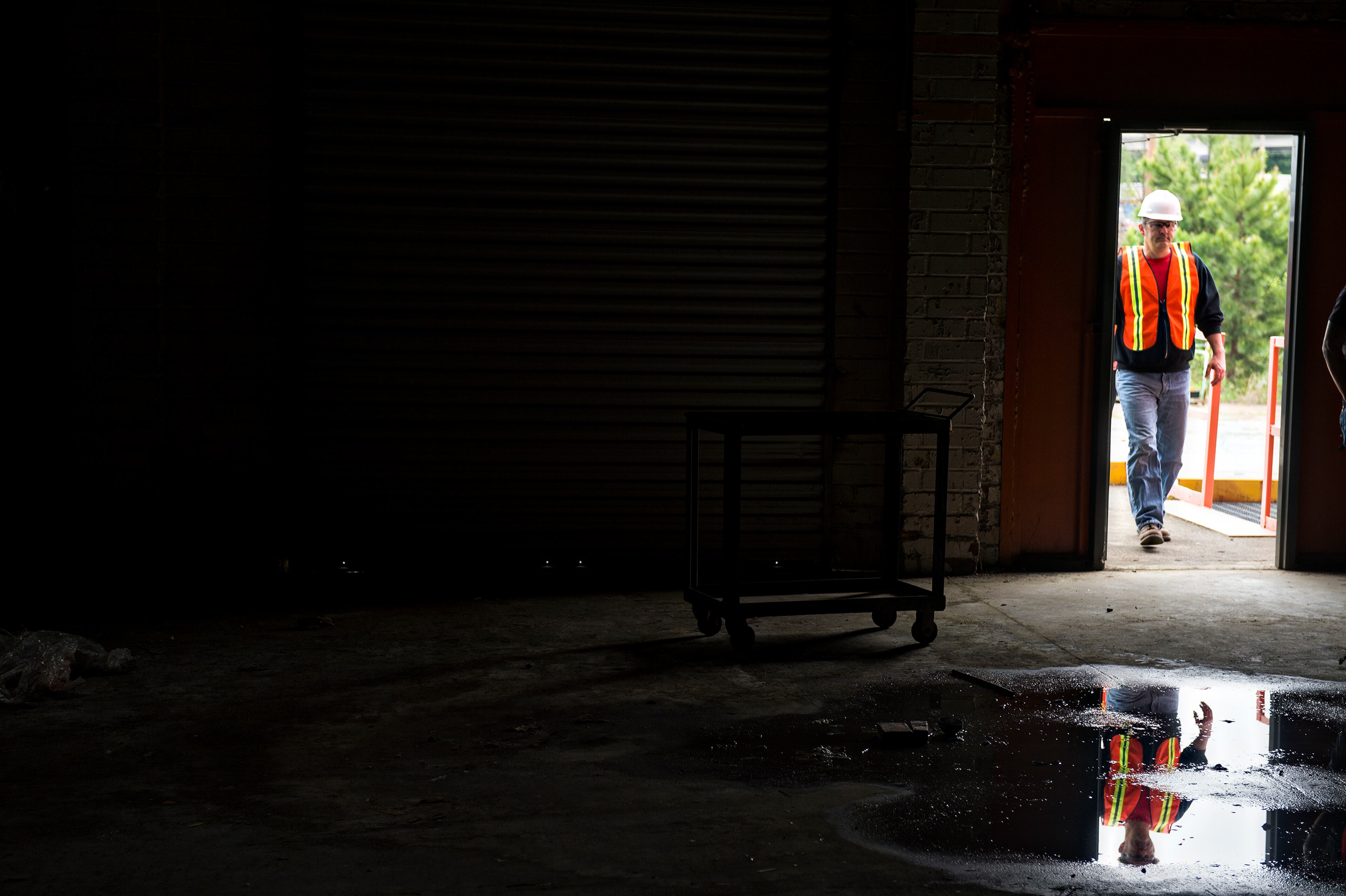 April 12, 2015 Doraville - Jeff Hornyak walks through a doorway into one of the buildings inside the General Motors assembly plant in Doraville during a #weloveatl photowalk on Sunday, April 12, 2015. 120 photographers were given special access to the plant that is being demolished and re-imagined into a multi-use space. JONATHAN PHILLIPS / SPECIAL