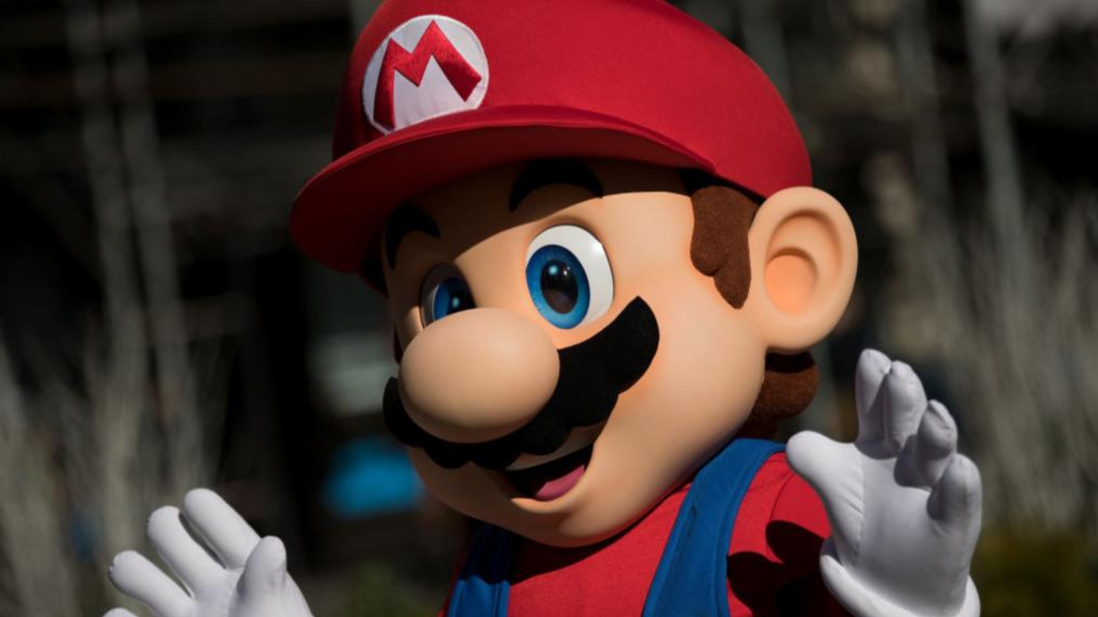 A person dressed as the Nintendo character Mario waves (Photo by Drew Angerer/Getty Images)