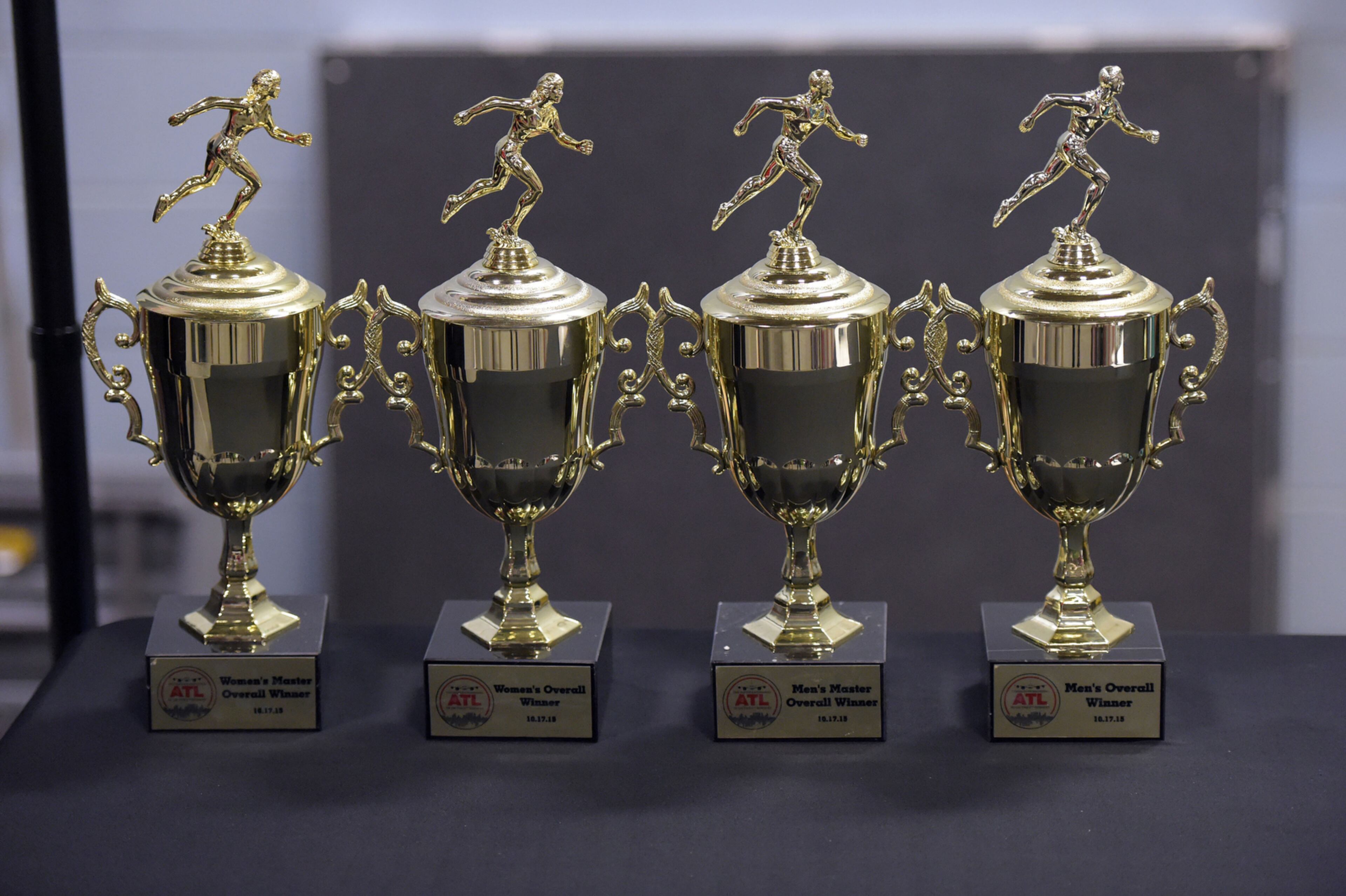 OCTOBER 17, 2015 ATLANTA Trophies for overall winners are shows prior to the race. Mayor Kasim Reed and United Way President Milton Little joined more than 2,000 runners at the Mayor’s Inaugural 5K on the 5th Runway at the world’s busiest airport Saturday, October 17, 2015. Airport officials shut down the 5th runway (Runway 10/28) until 8:15 am so runners and walkers could exit the course. All proceeds from the event will benefit United Way of Greater Atlanta. Major sponsors of The Mayor’s Inaugural 5K on the 5th Runway include Delta Air Lines, The Coca-Cola Company, Enterprise Rental Car, Georgia International Convention Center, MARTA, and Publix. Over $123,000 was raised, said airport spokesman Reese McCranie. The race's overall winner was Andrew Murfee, 15, a Woodward Academy student. KENT D. JOHNSON/KDJOHNSON@AJC.COM