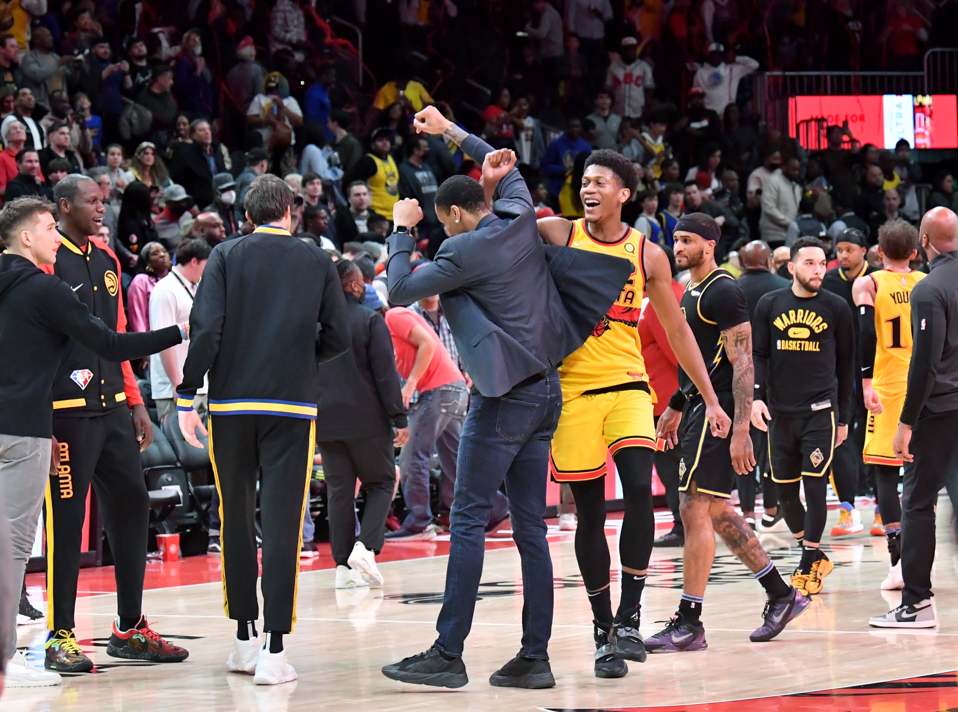 Hawks' forward De'Andre Hunter (center right) celebrates with John Collins (center left) after winning over Golden State Warriors in an NBA basketball game at State Farm Arena on Friday, March 25, 2022. Atlanta Hawks won 121-110 over Golden State Warriors. (Hyosub Shin / Hyosub.Shin@ajc.com)