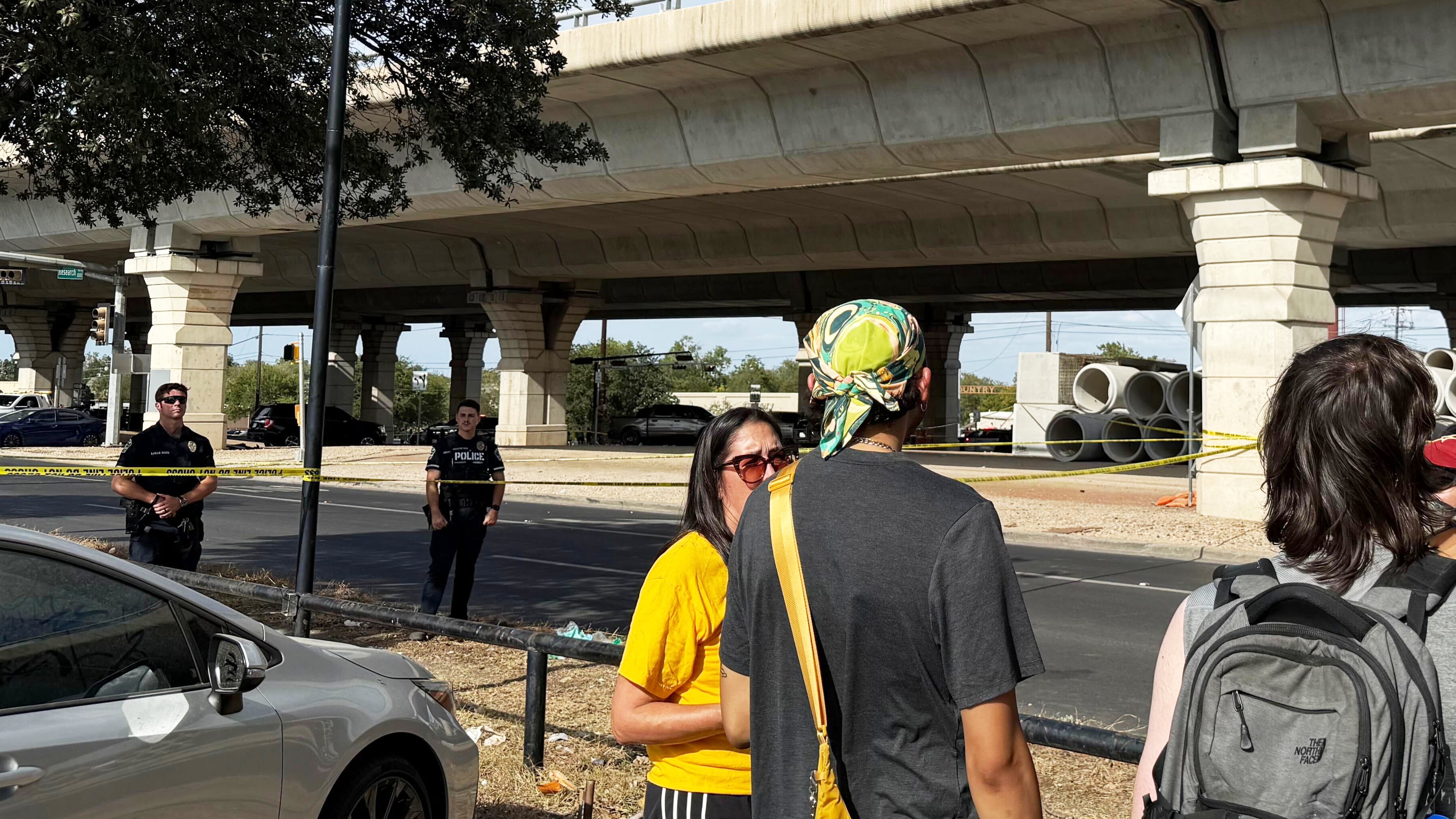 In this photo taken with a smart phone Police block a street after a shooting involving an ICE officer in Austin, Texas, Sunday, Sept. 20, 2026. (AP Photo/Jesse Bedayn)