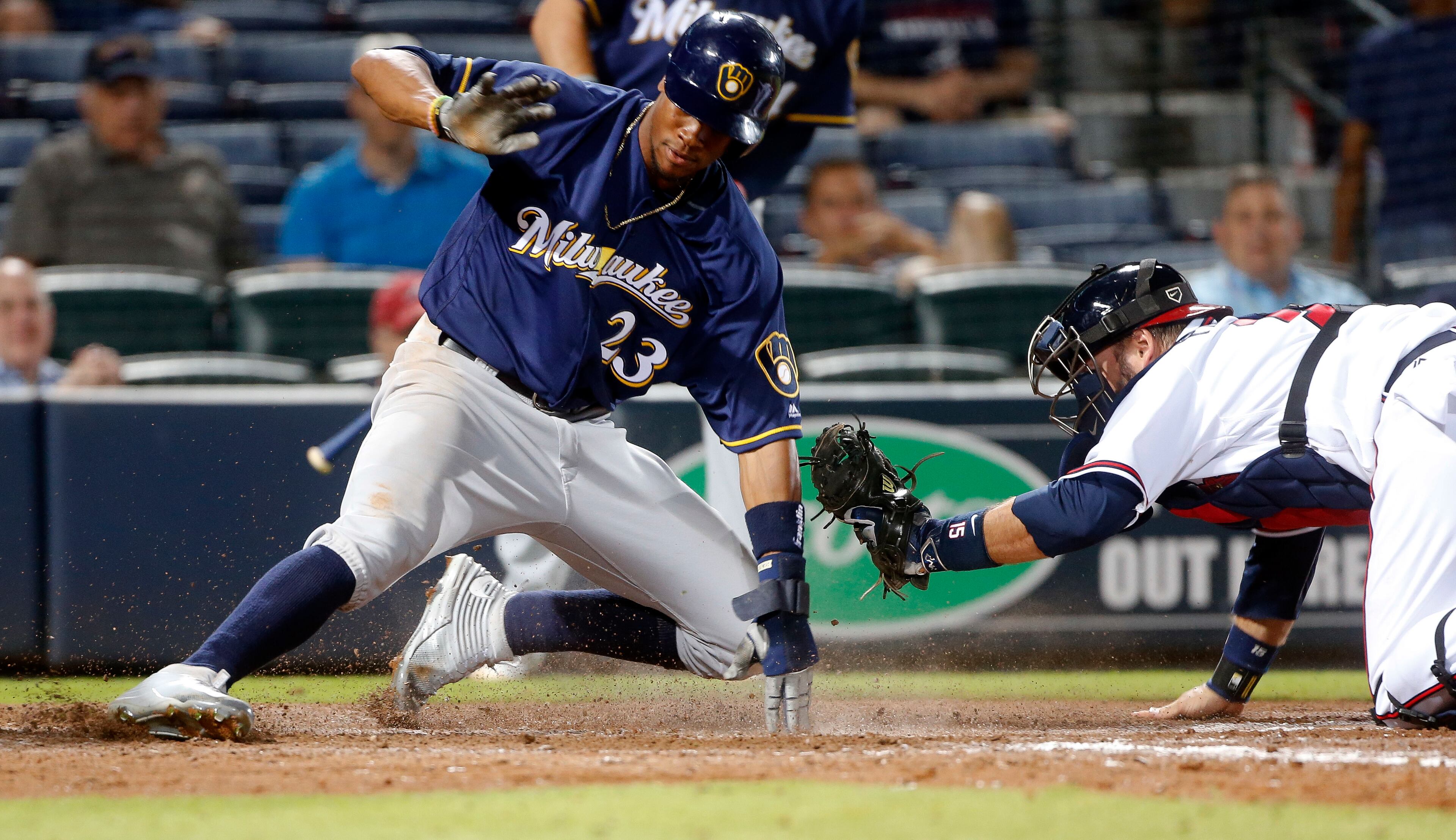 Milwaukee Brewers' Keon Broxton (23) is out at home plate after being tagged by Atlanta Braves catcher A.J. Pierzynski (15) on a Jonathan Villar base hit in the 13th inning of baseball game Thursday, May 26, 2016, in Atlanta. Milwaukee won 3-2. (AP Photo/John Bazemore)