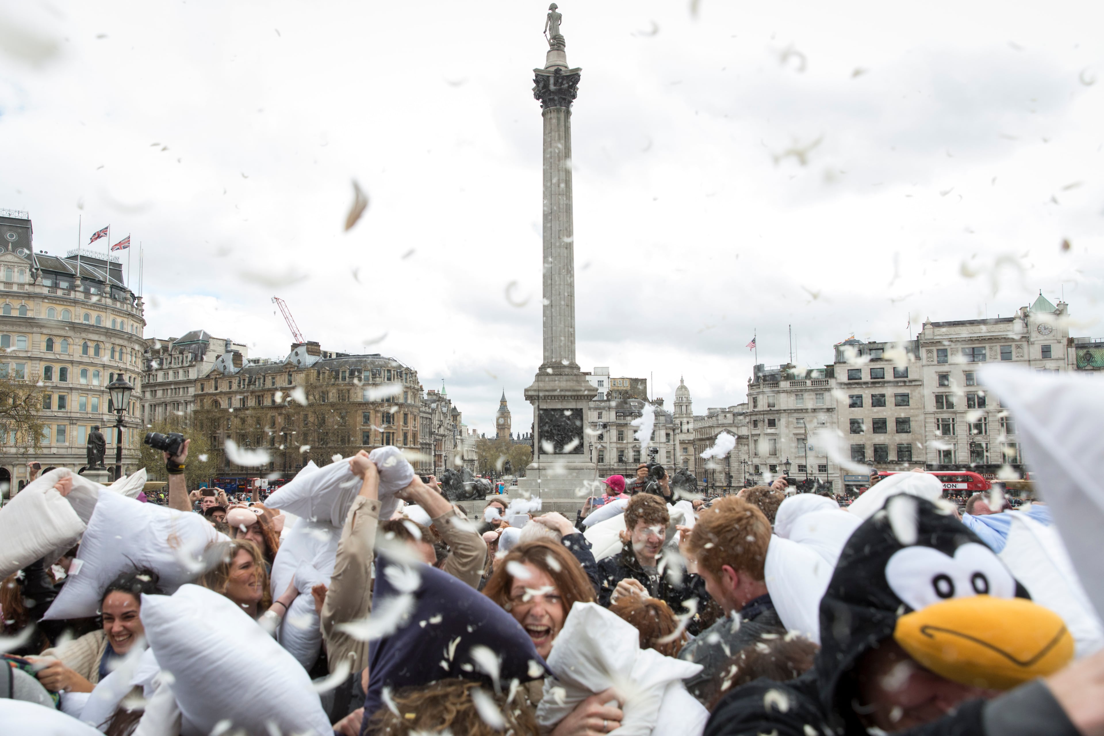 LONDON, ENGLAND - APRIL 05: Revellers take part in a giant pillow fight on the north terrace of Trafalgar Square on 'International Pillow Fight Day' on April 5, 2014 in London, England. Pillow fights have been organised numerous other cities around the world simultaneously. (Photo by Rob Stothard/Getty Images)