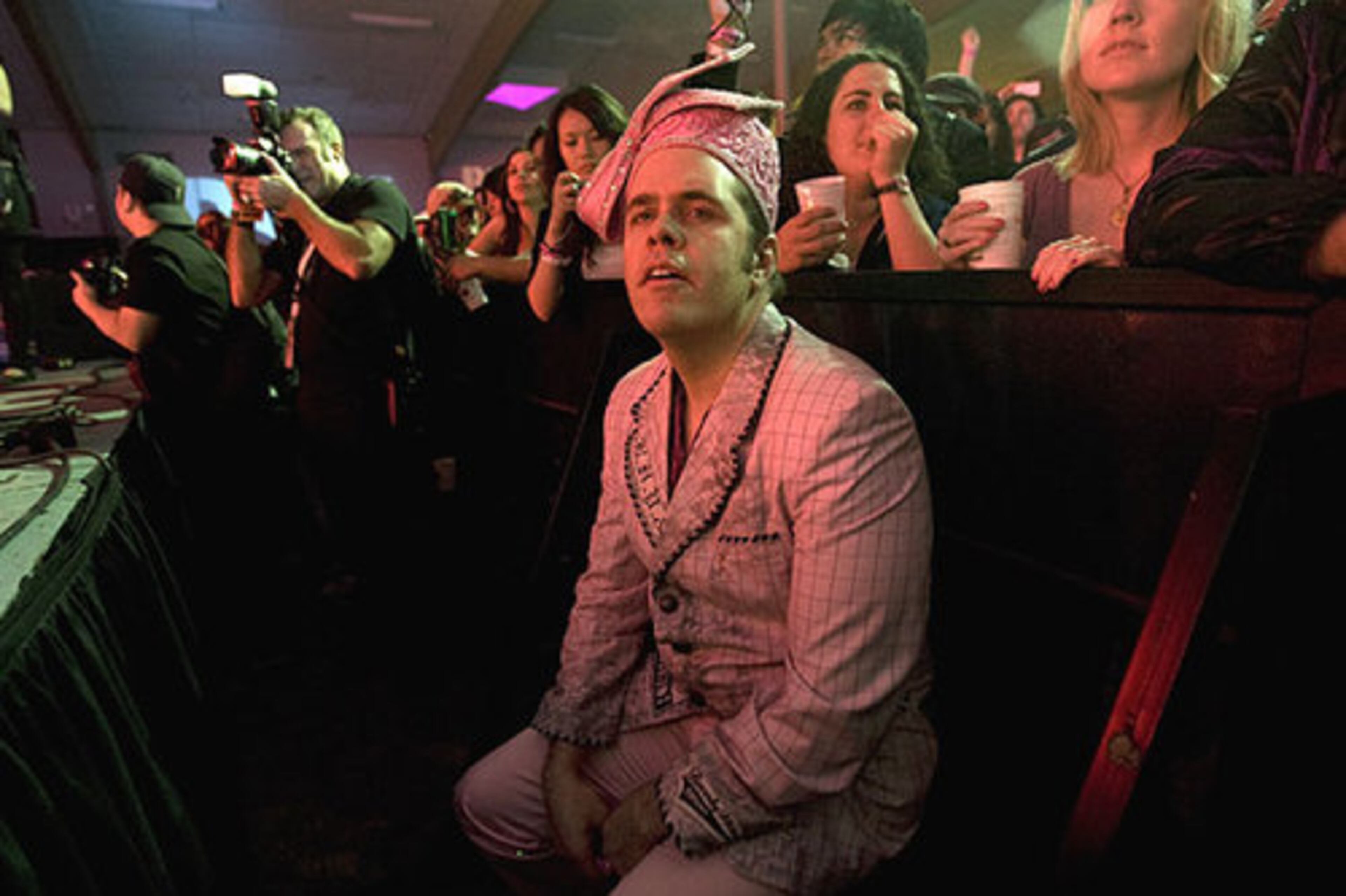 At his Austin party, celeb gossip blogger Perez Hilton watches Natalie Portman's Shaved Head perform.