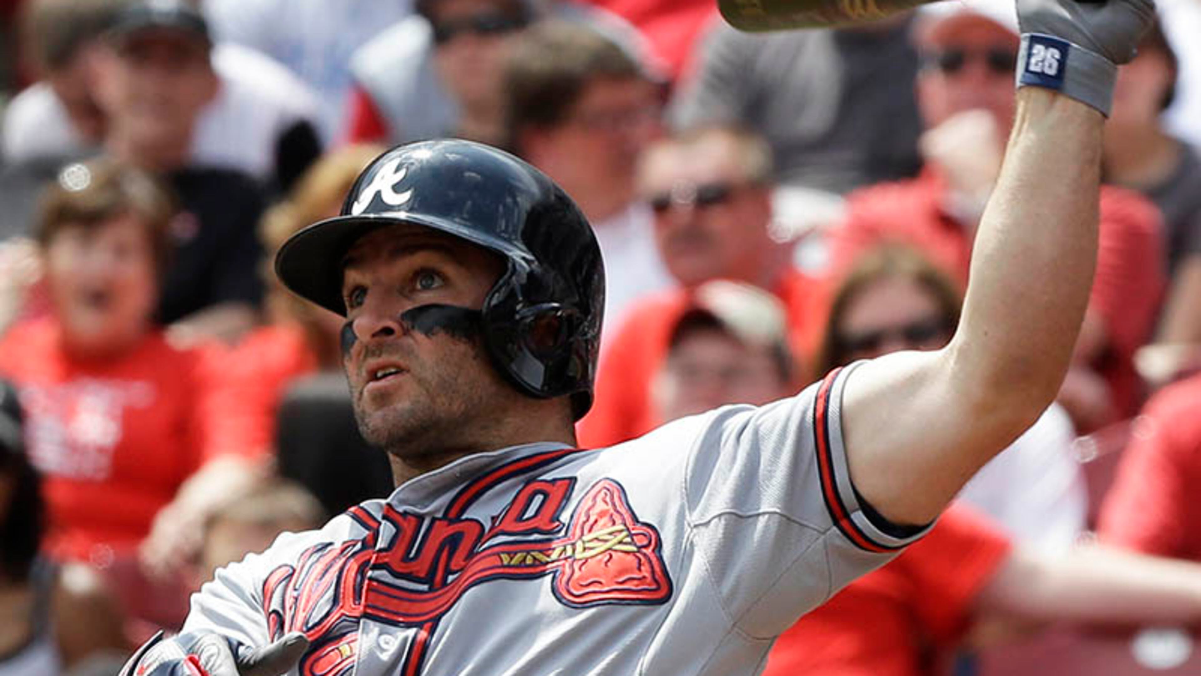 Braves second baseman Dan Uggla hits his second homer of the game in the sixth inning off Reds pitcher Mike Leake.