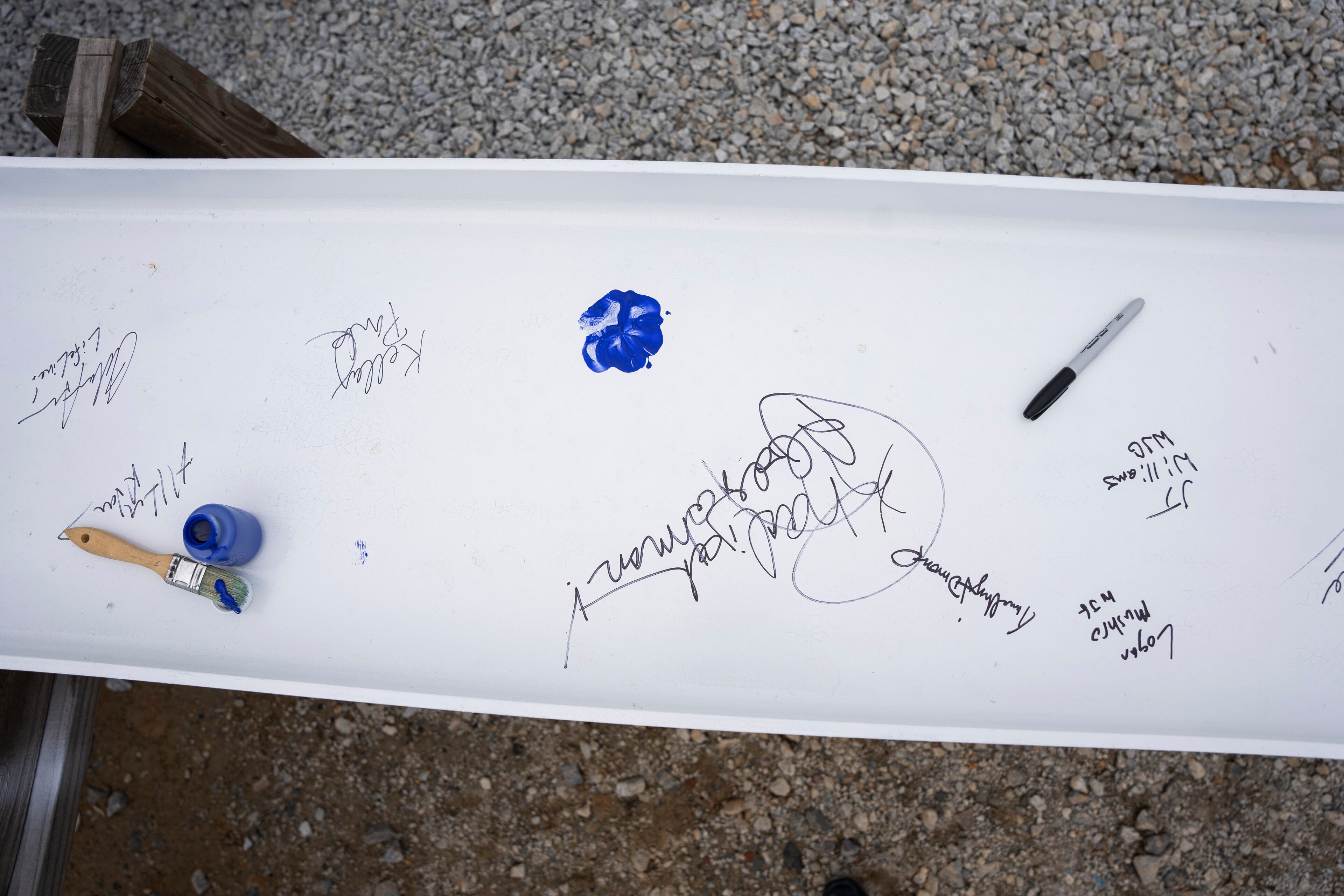 Names are signed and paws printed on the inaugural beam that will be built into the new animal shelter which is set to open this fall in Fulton County, on Friday, May 19, 2023. (Olivia Bowdoin for the Atlanta Journal Constitution).