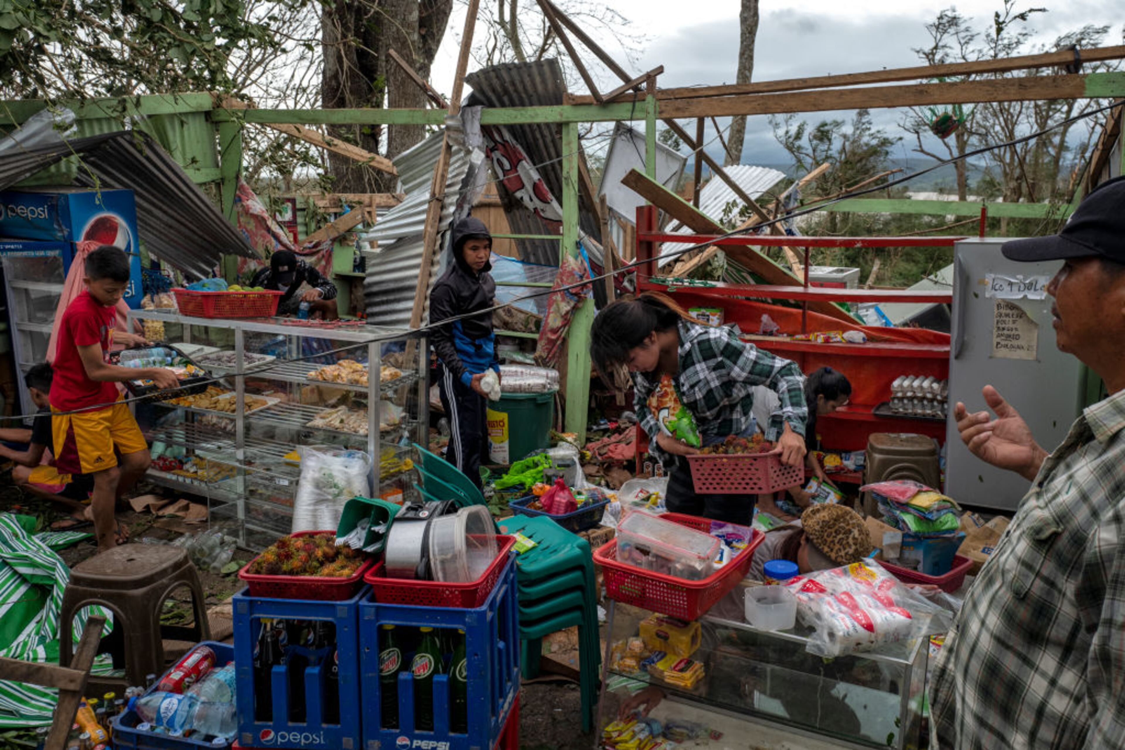 GATTARAN, PHILIPPINES - SEPTEMBER 15: Residents gather usable items after their property was destroyed by typhoon Mangkhut on September 15, 2018 in Gattaran, Philippines. Typhoon Mangkhut battered northern Philippines as it made landfall Saturday morning leaving at least five people dead and millions of pesos in damages. (Photo by Jes Aznar/Getty Images)