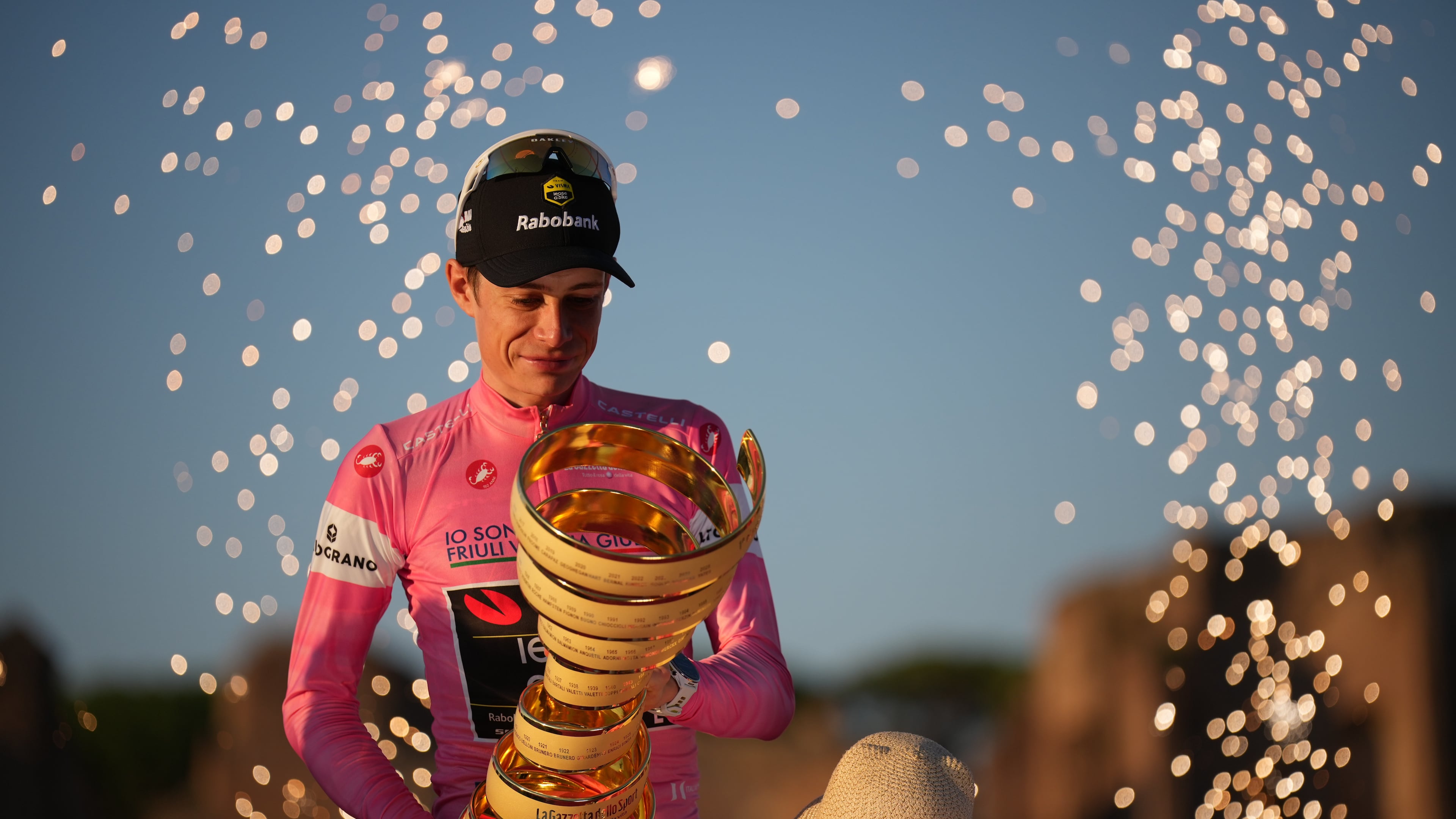 First placed Denmark's Jonas Vingegaard holds the trophy as he celebrates on the podium at the end of the Giro d'Italia cycling race in Rome Sunday, May 31, 2026. (AP Photo/Andrew Medichini)