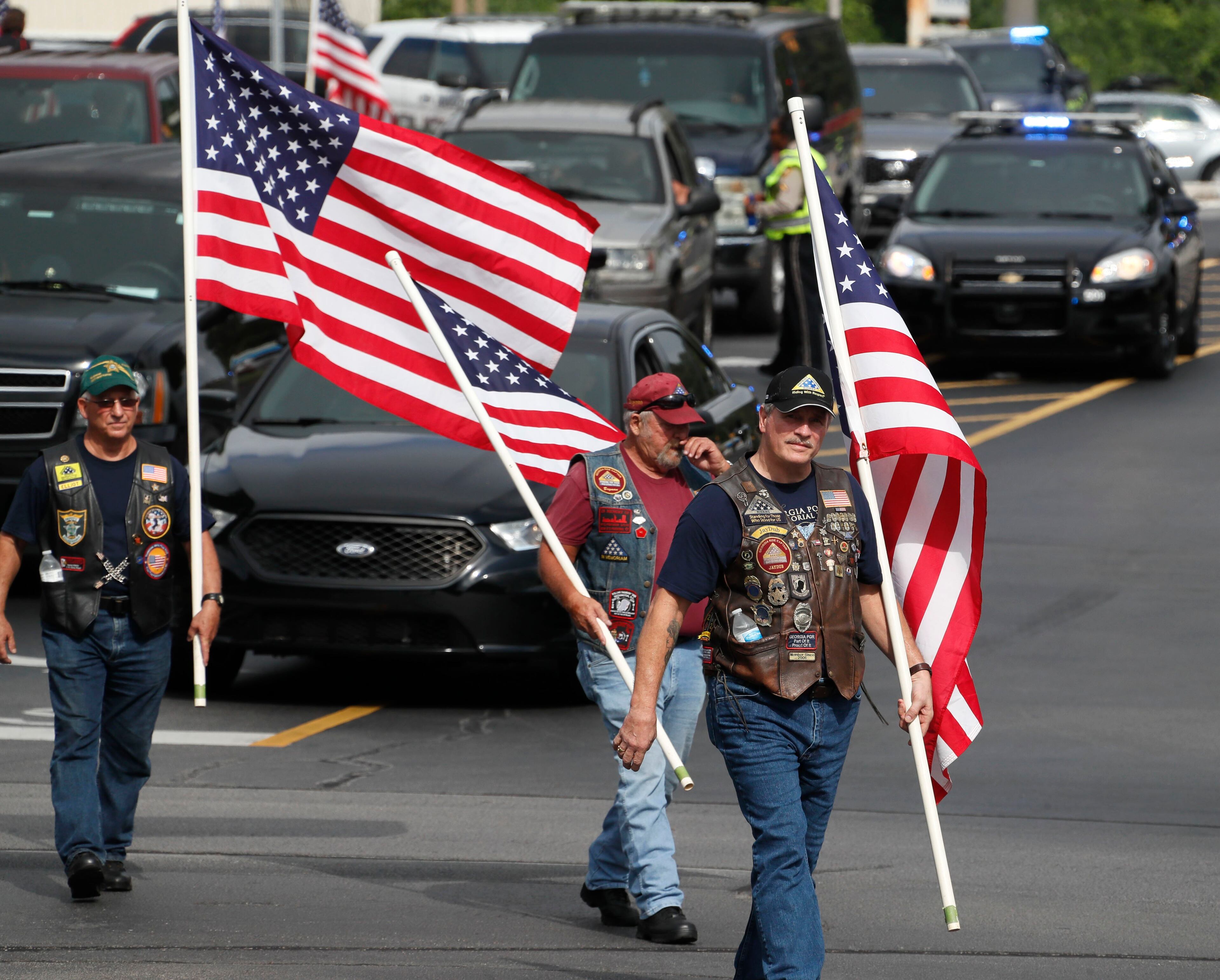 July 11, 2019, 2019 - Gainesville - Members of the Patriot Guard Riders arrive with flags they held as the hearse arrived. A funeral service was held for slain Hall County Sheriff's Deputy Nicolas Blane Dixon, the fourth Georgia law enforcement officer killed in the line of duty this year. The service was held at Free Chapel Worship Center in Gainesville. Bob Andres / bandres@ajc.com