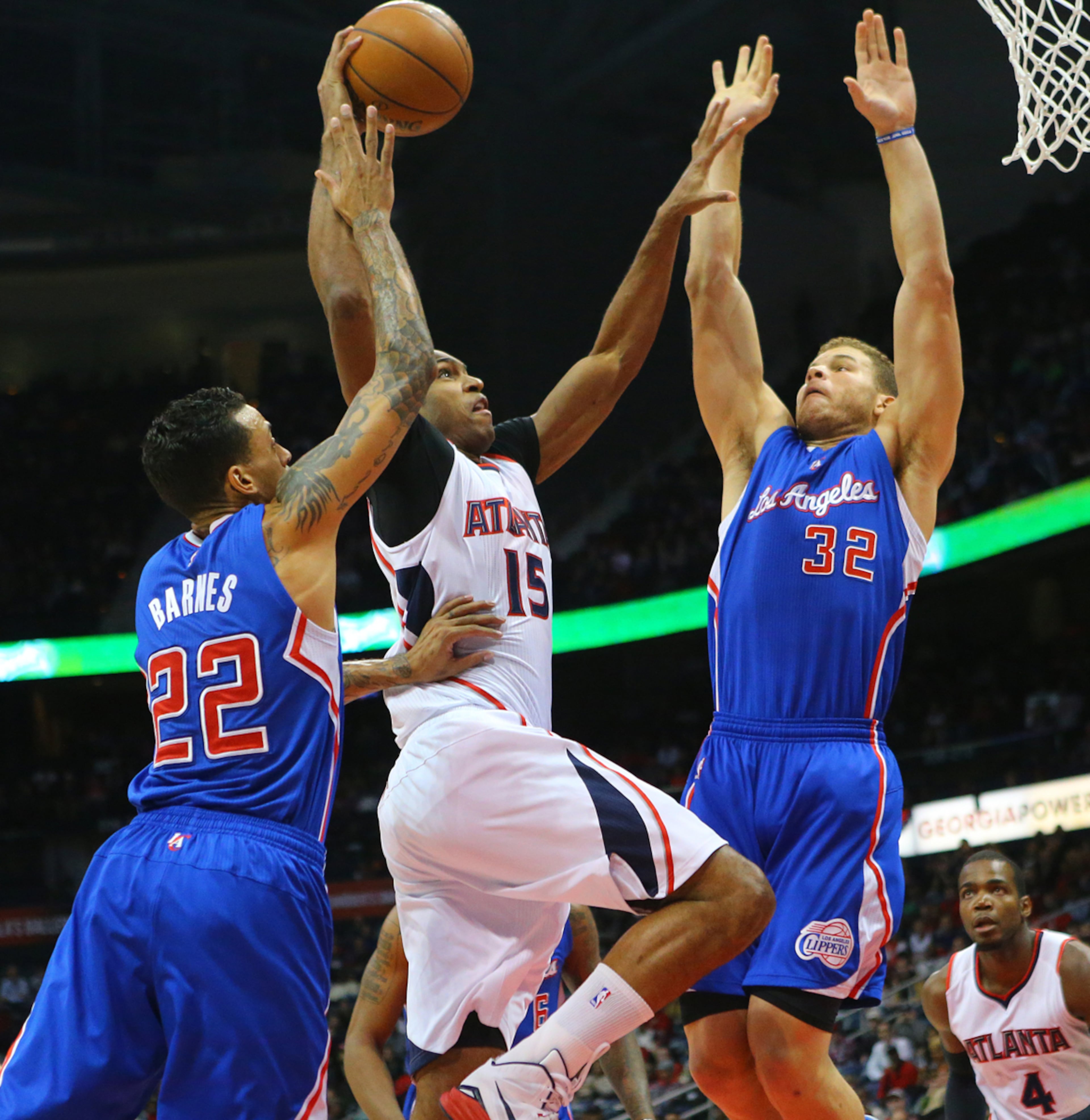 DRIVING THE LANE--122314 ATLANTA: Hawks center Al Horford draws a foul from Clippers Matt Barnes (left) taking it to the basket past Blake Griffin (right) in a basketball game on Monday, Dec. 23, 2014, in Atlanta. Curtis Compton / ccompton@ajc.com