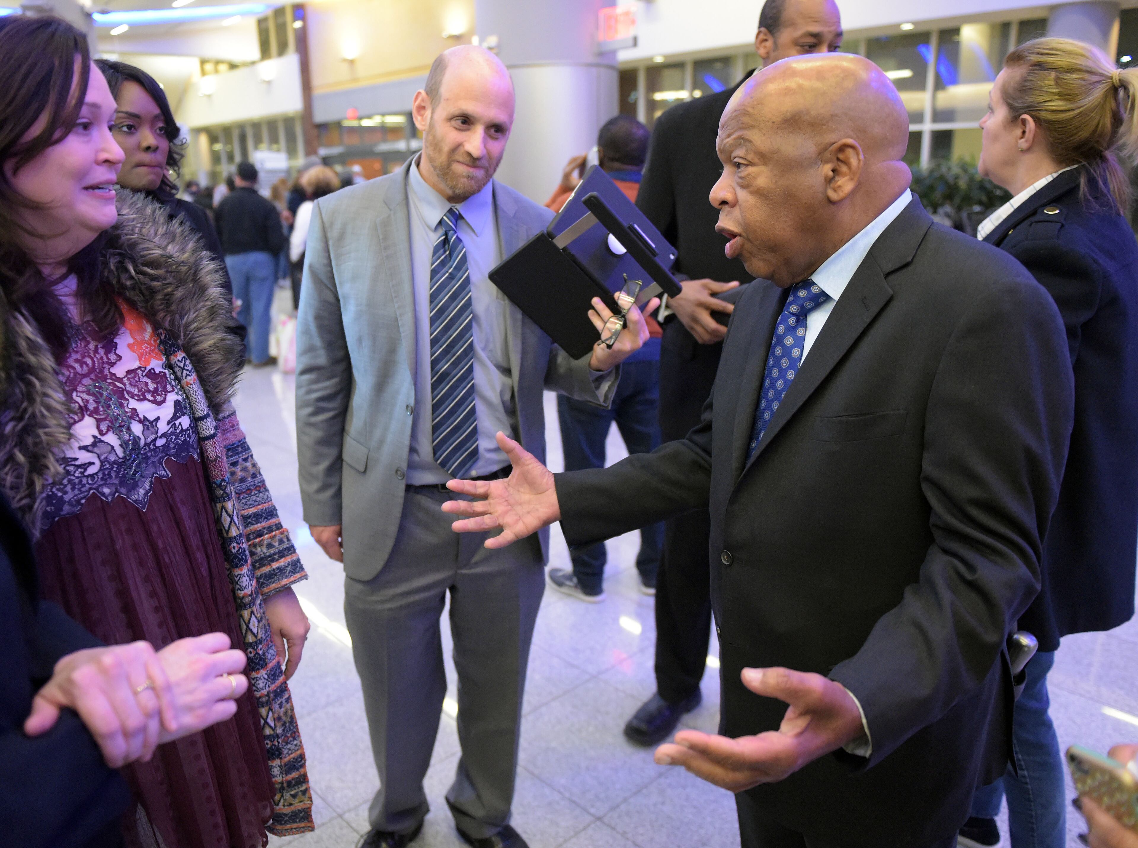 JANUARY 28, 2017 ATLANTA U.S. Congressman John Lewis (D-Ga, right) speaks with attorneys Sarah Owings and Daniel Werner outside the Customs and Border Protection office at Hartsfield Jackson International airport Saturday January 25, 2017 after at least 4 people were detained earlier today after an executive order from President Trump limited immigration into the United States. Kent D. Johnson/AJC