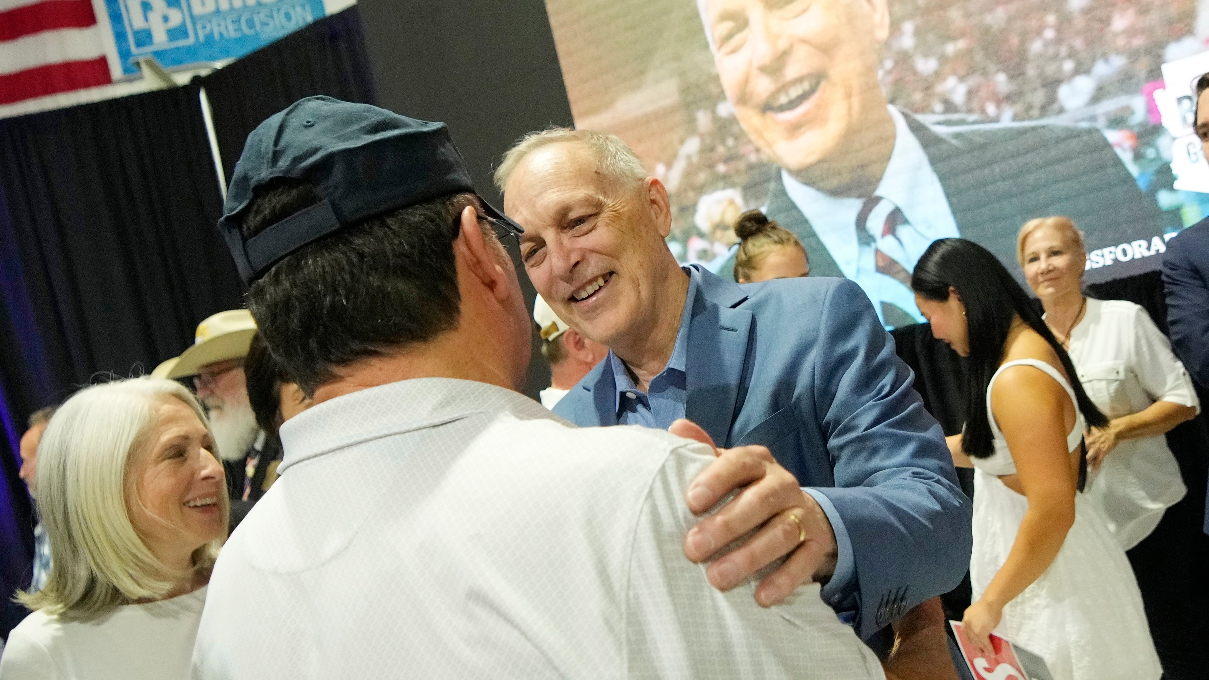 Arizona Republican gubernatorial candidate U.S. Rep. Andy Biggs, right, greets a supporter after being declared the winner in the primary, Tuesday, July 21, 2026, in Scottsdale, Ariz. (AP Photo/Ross D. Franklin)