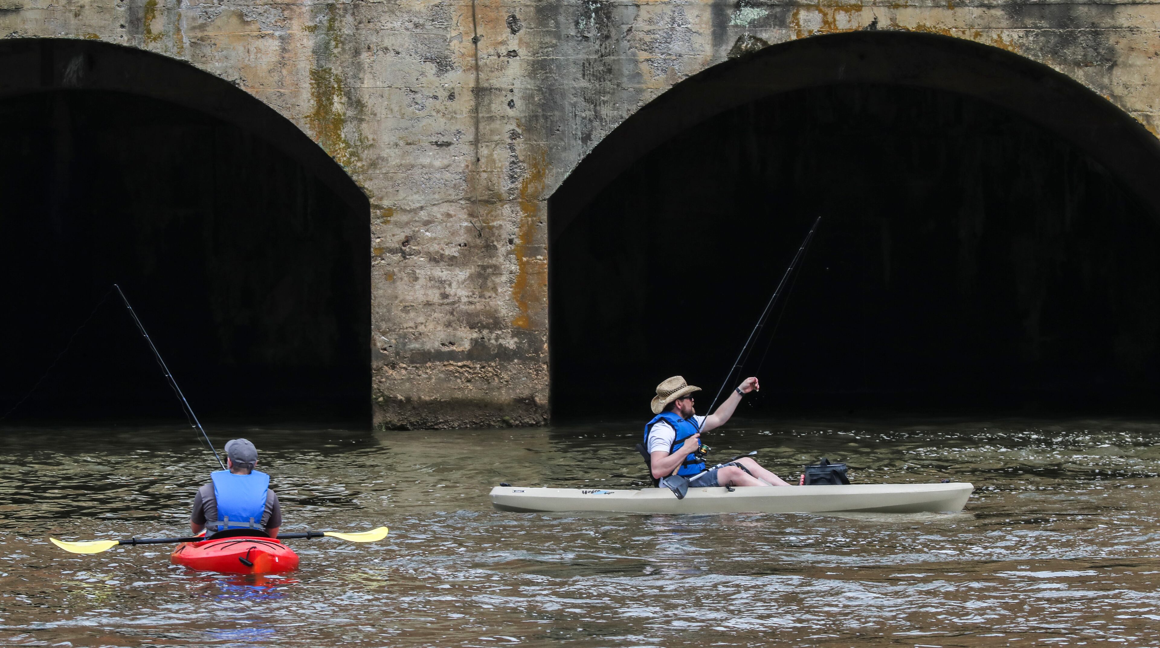 Getting ahead of the coming rains, Seth Nelson (left) from Washington D.C. in town visiting his brother, Eric Nelson (right) from Alpharetta went fishing at Morgan Falls Overlook Park in Sandy Springs on Wednesday, April 13, 2022. (John Spink / John.Spink@ajc.com)