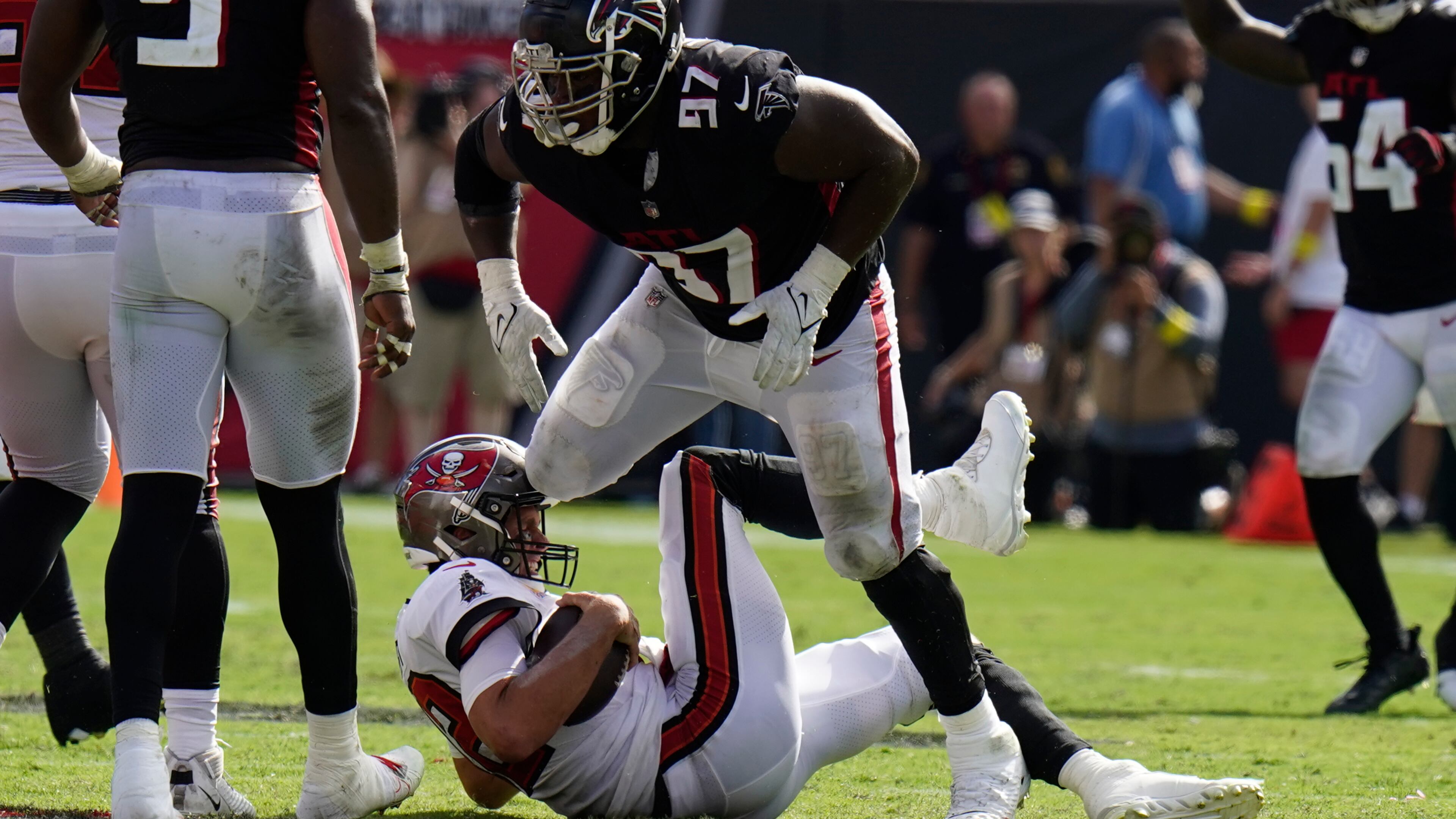 Falcons defensive end Grady Jarrett (97) takes down Tampa Bay Buccaneers quarterback Tom Brady (12) during the second half of an NFL football game Sunday, Oct. 9, 2022, in Tampa, Fla. Jarrett was called for a penalty. (AP Photo/Chris O'Meara)