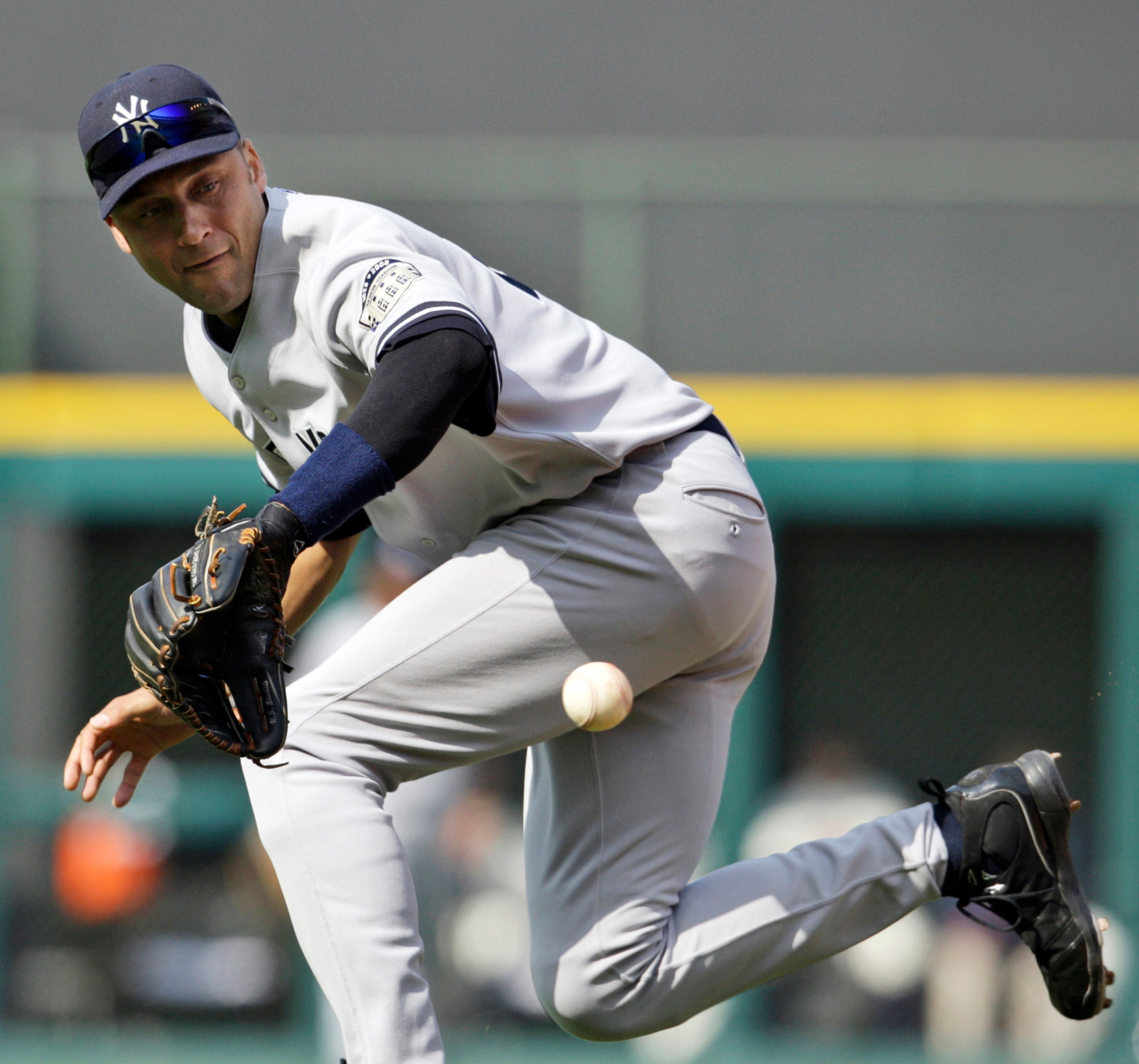 FILE - In this April 26, 2008, file photo, New York Yankees' Derek Jeter reaches for a ball hit by Cleveland Indians' Jhonny Peralta in the second inning of a baseball game in Cleveland. A five-time World Series champion and sixth on the career hits list, Jeter, now 40, is set to retire after this season after spending two decades as the shortstop for the Yankees. (AP Photo/Ron Schwane, File)