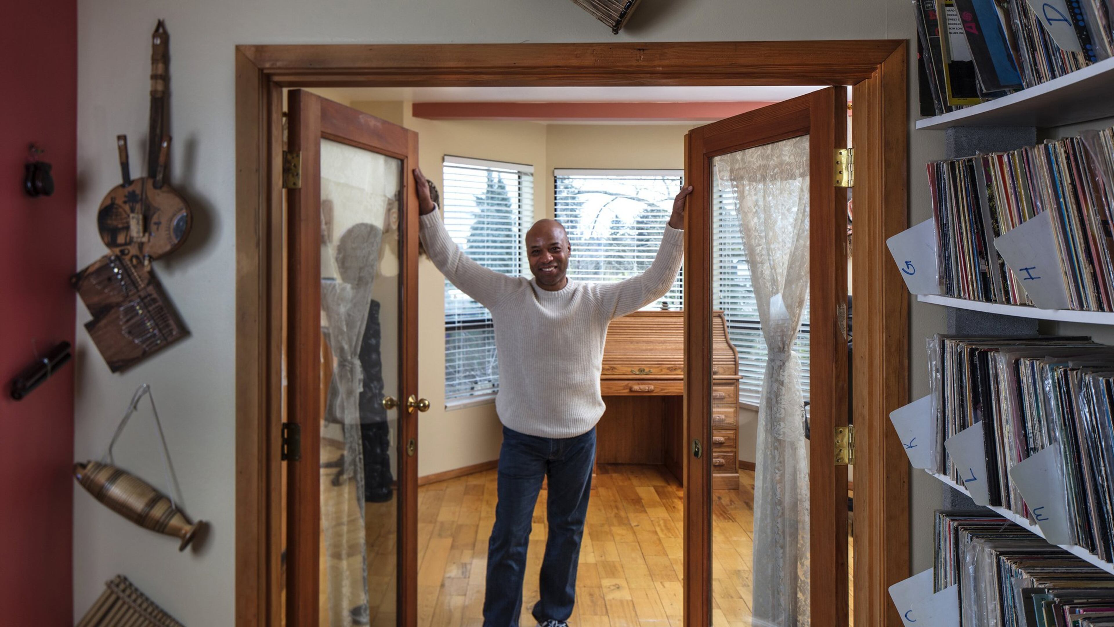 Kevin Howard has spent 30 years remodeling and adding on to his 1907 home. The design is based on everything being oversized, he says. Master suite, large rooms, high ceilings, French doors that connect rooms, open kitchen plans, formal dining areas and the Lake Washington view. His 3,000 historic jazz albums, alphabetized, fill the music-room shelves to the right. (Steve Ringman/The Seattle Times/TNS)