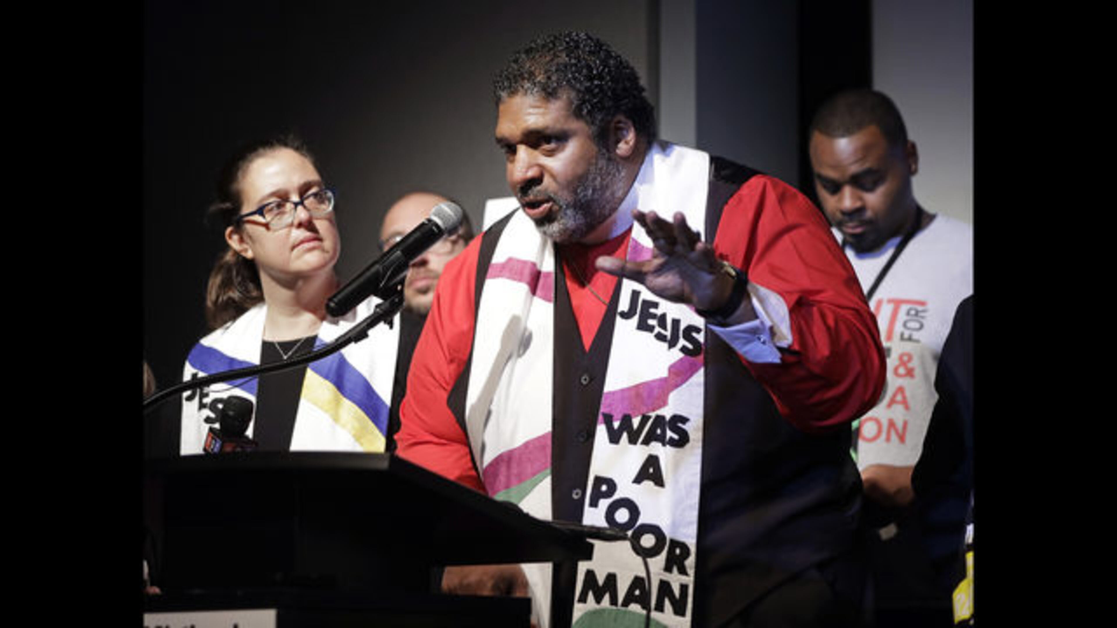 The Rev. Dr. William J. Barber II (second from left) and the Rev. Dr. Liz Theoharis (left), co-chairs of the Poor People's Campaign, speak at the National Civil Rights Museum earlier this year in Memphis, Tenn. (AP Photo/Mark Humphrey)