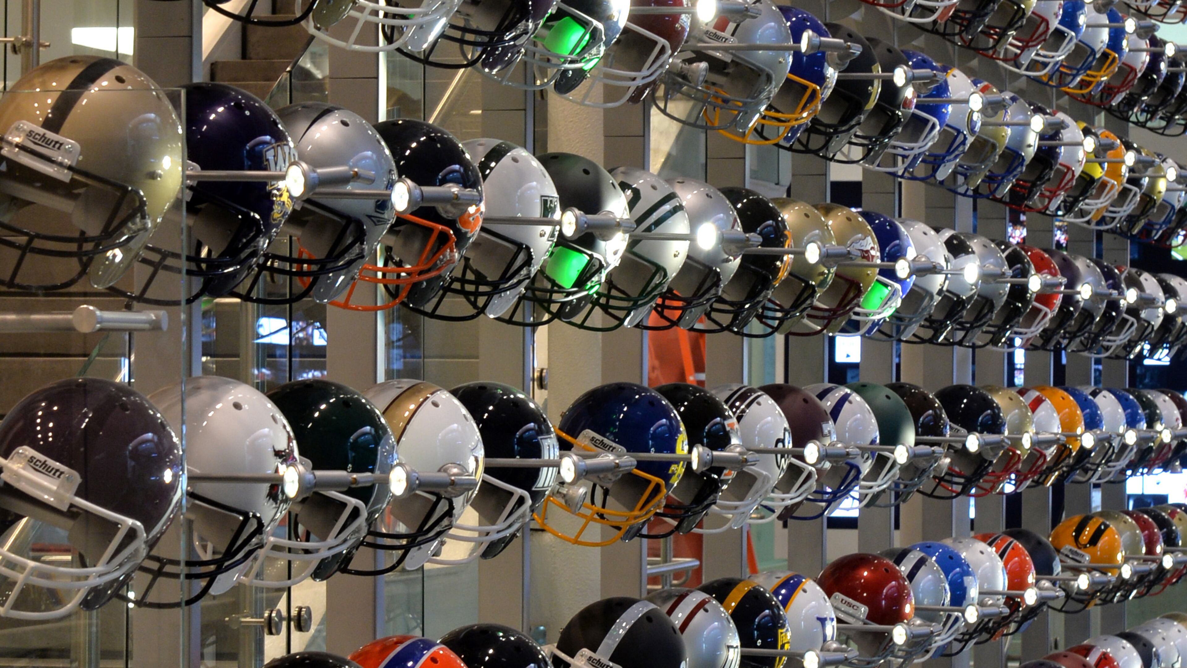 A 40-foot-high wall with more than 700 football helmets representing every Division I, Division II, Division III and NAIA program highlight The Quad in the new College Football Hall of Fame in Atlanta. BRANT SANDERLIN /BSANDERLIN@AJC.COM