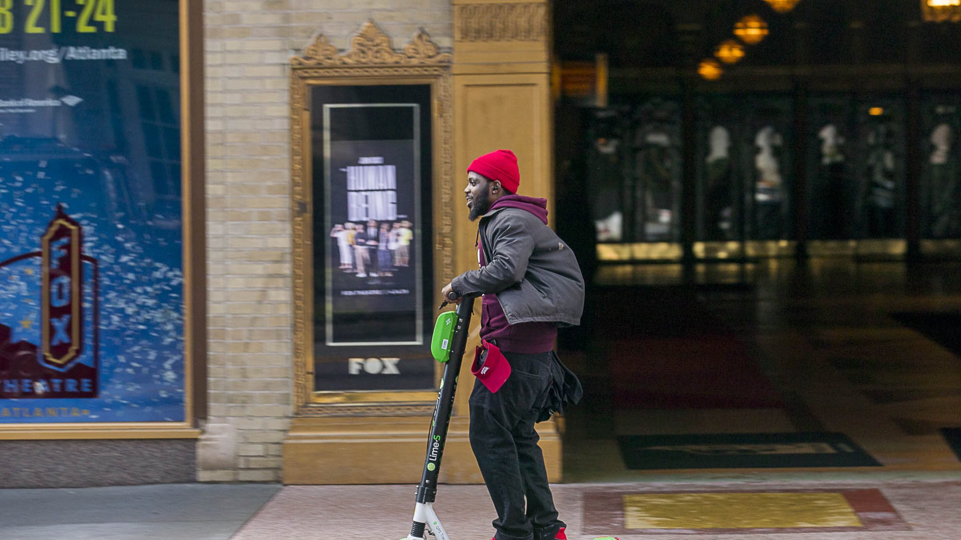 01/04/2019 — Atlanta, Georgia — A man rides a Lime Scooter along Peachtree Street in Atlanta’s Midtown community, Friday, January 4, 2019. (ALYSSA POINTER/ALYSSA.POINTER@AJC.COM)