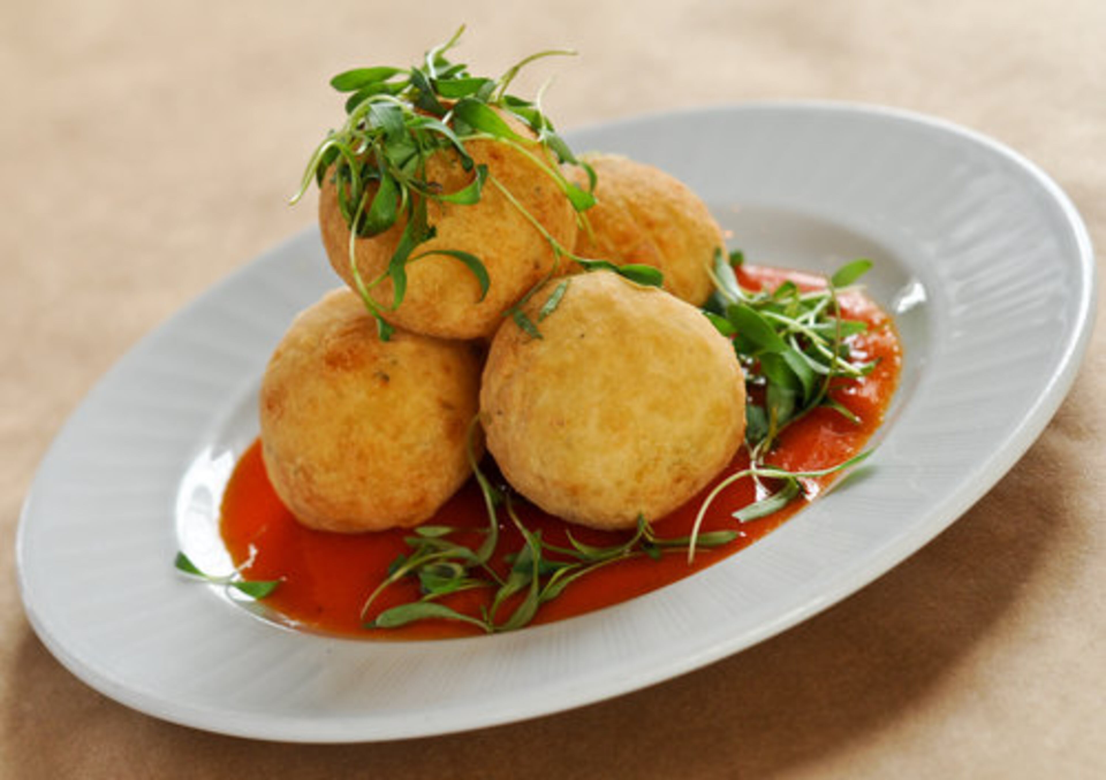 The bolinho de apim con carne -- yucca fritters, ground beef and sweet malagueta pepper sauce -- at Botekim Brazilian Bistro in Marietta. John Kessler calls it, "a sweet surprise in east Cobb County's burgeoning Little Brazil." Two stars.