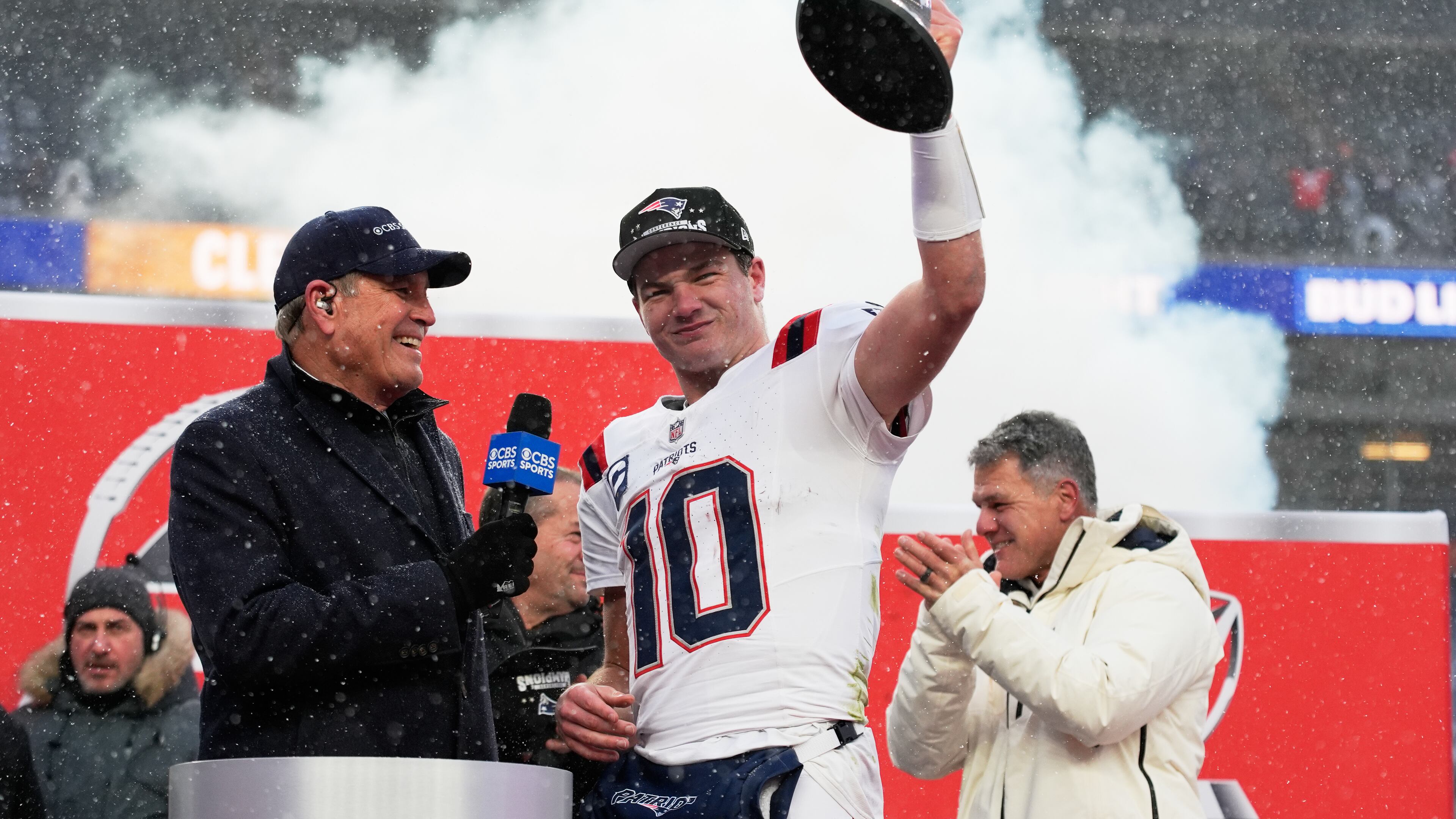 New England Patriots quarterback Drake Maye celebrates with the trophy after the AFC Championship NFL football game between the Denver Broncos and the New England Patriots, Sunday, Jan. 25, 2026, in Denver. (AP Photo/John Locher)
