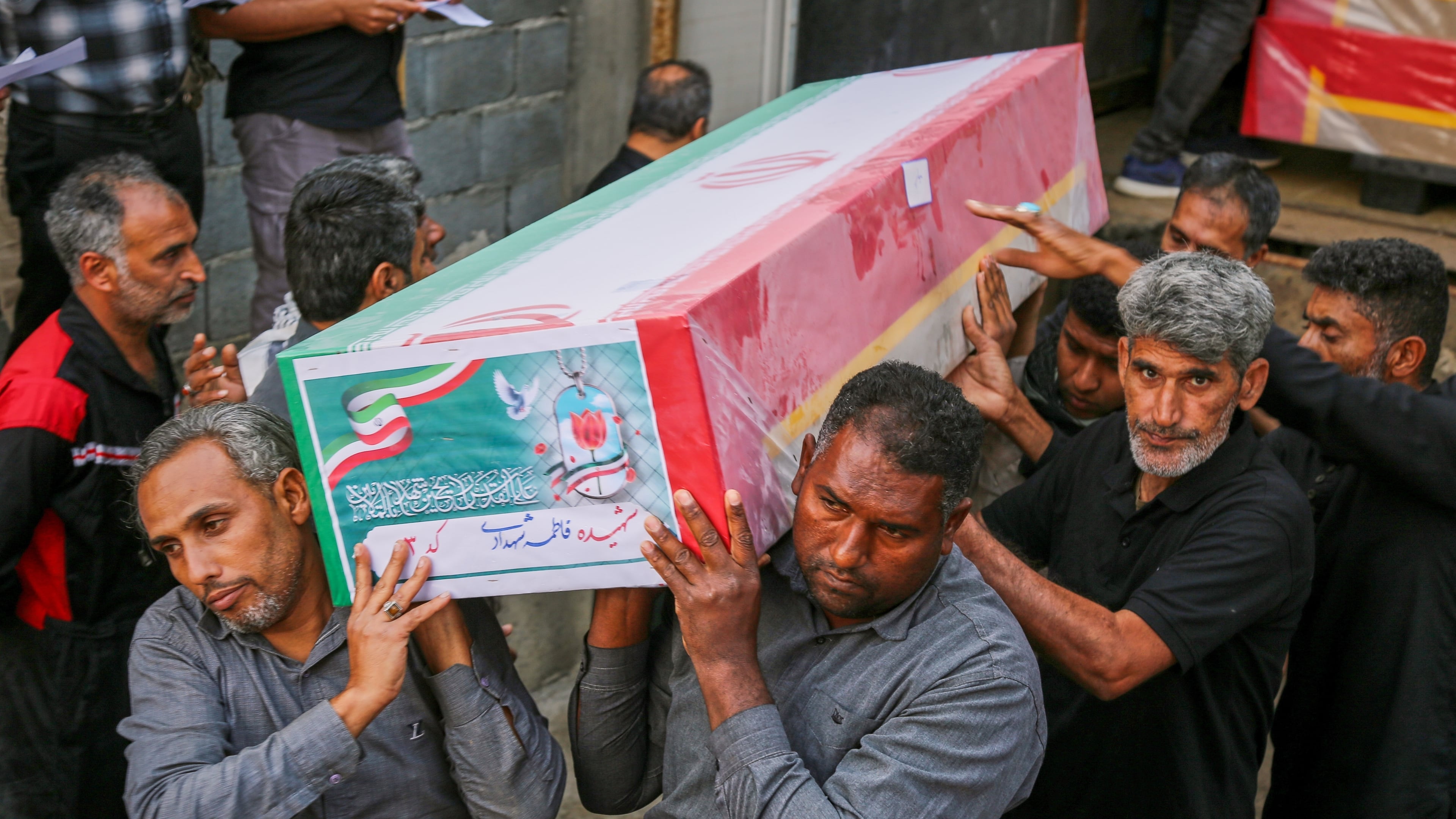 A coffin is carried during the funeral of victims — mostly children — killed in a strike Feb. 28 at a girls' elementary school in Minab, Iran, Tuesday, March 3, 2026. (Abbas Zakeri/Mehr News Agency via AP)