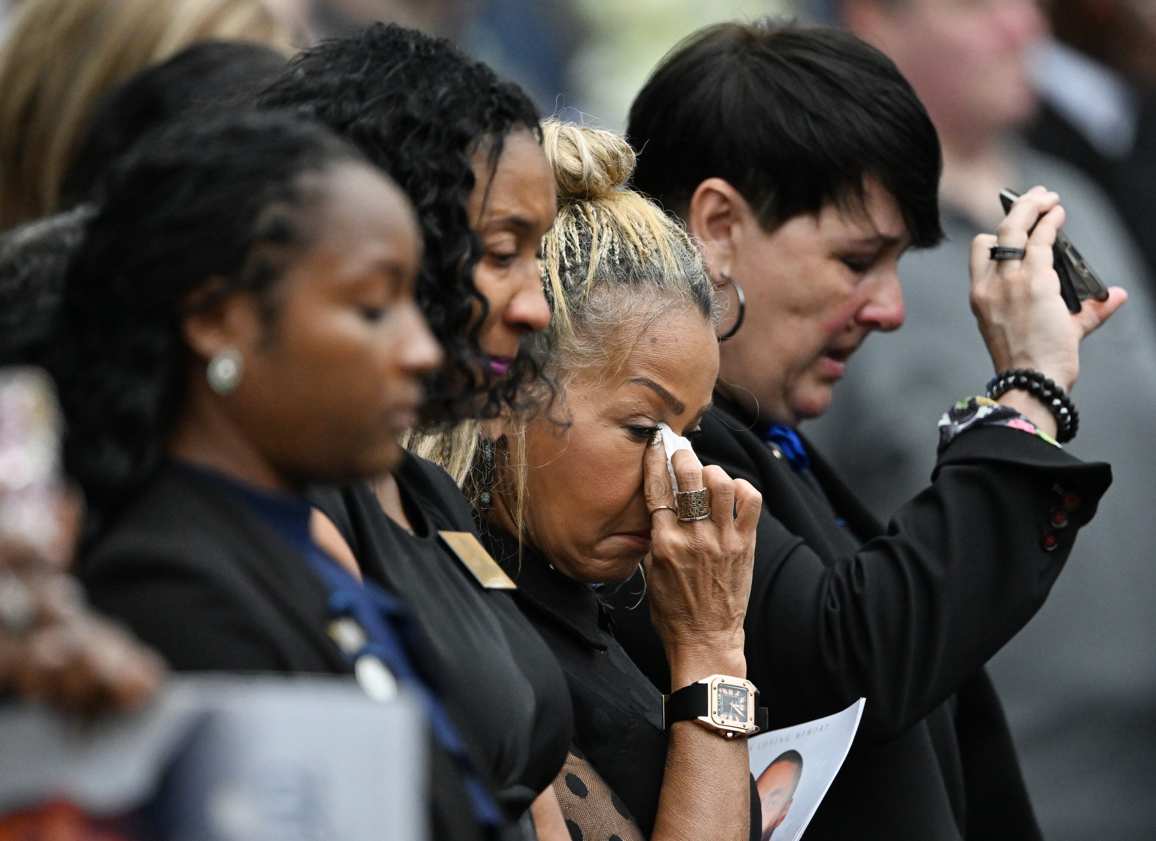 Mourners react during the Final Honors following the memorial service for DeKalb County police Officer David Rose, who was killed while responding to the Aug. 8 shooting at the CDC, outside the First Baptist Church Atlanta, Friday, August 22, 2025, in Atlanta. Hyosub Shin / AJC)