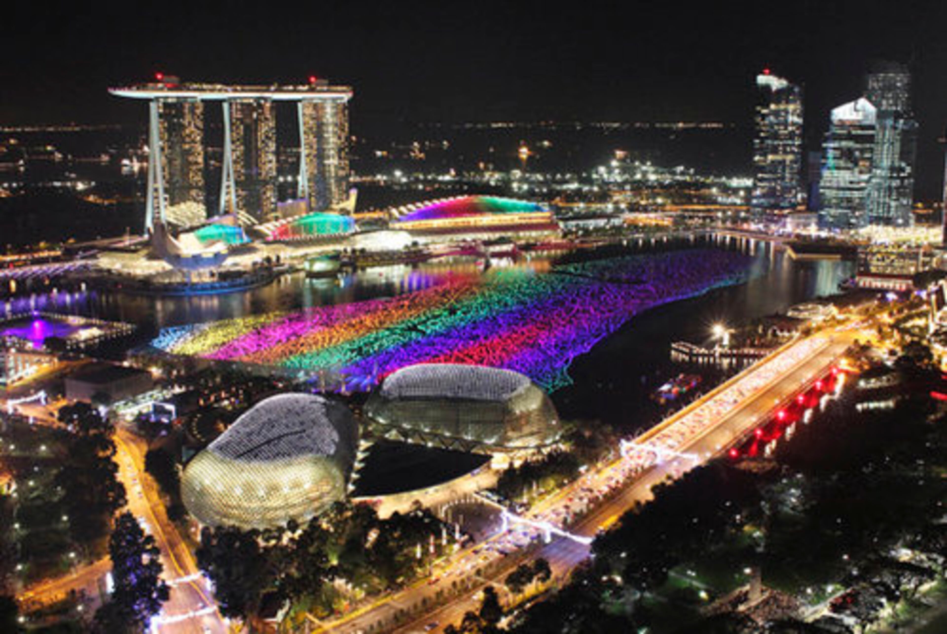 Lights fashion Singapore's financial district before massive fireworks display highlighting New Year's celebrations.