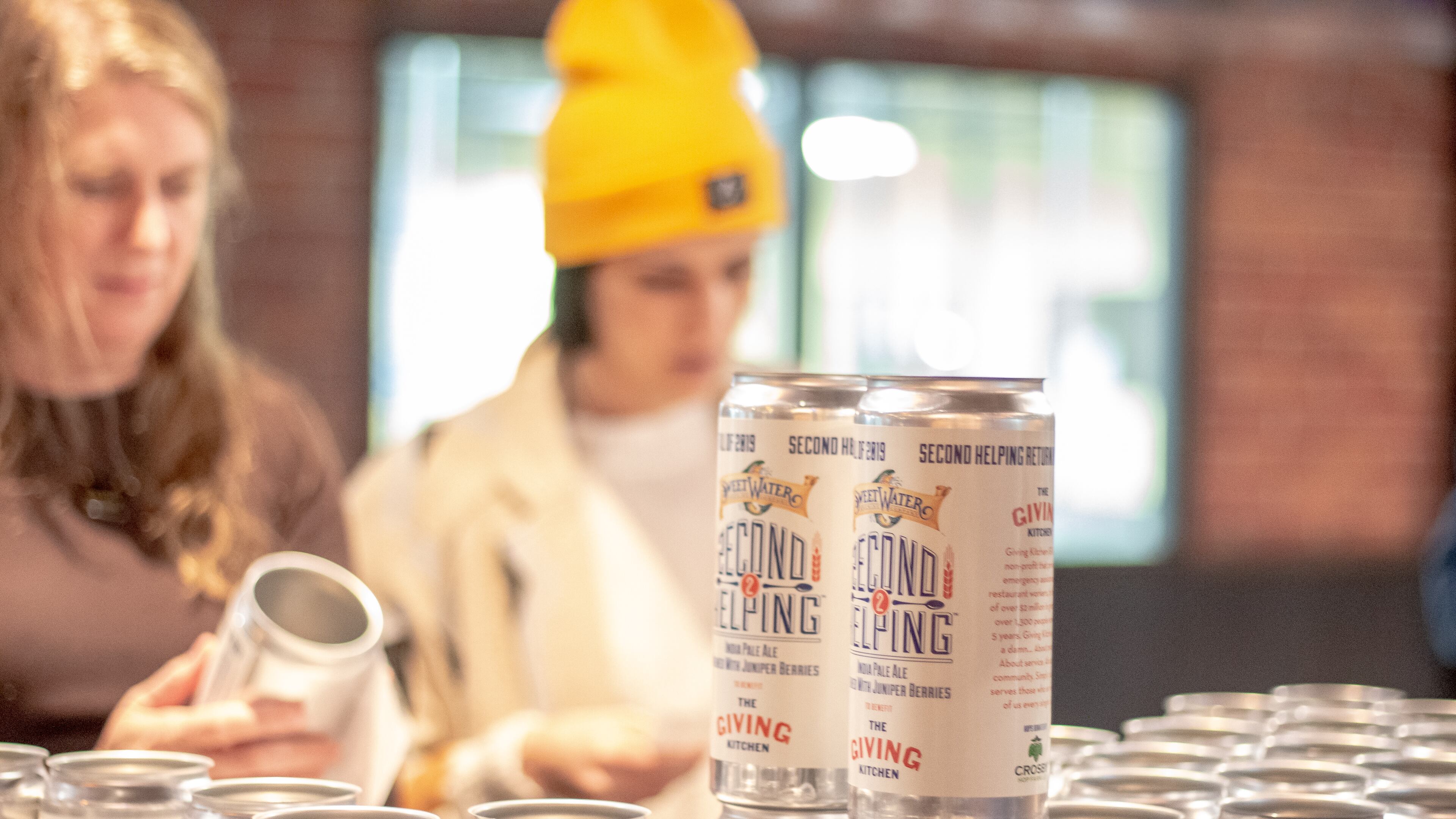 A fresh batch of SweetWater Second Helping IPA in crowlers. Credit: SweetWater Brewing Co.