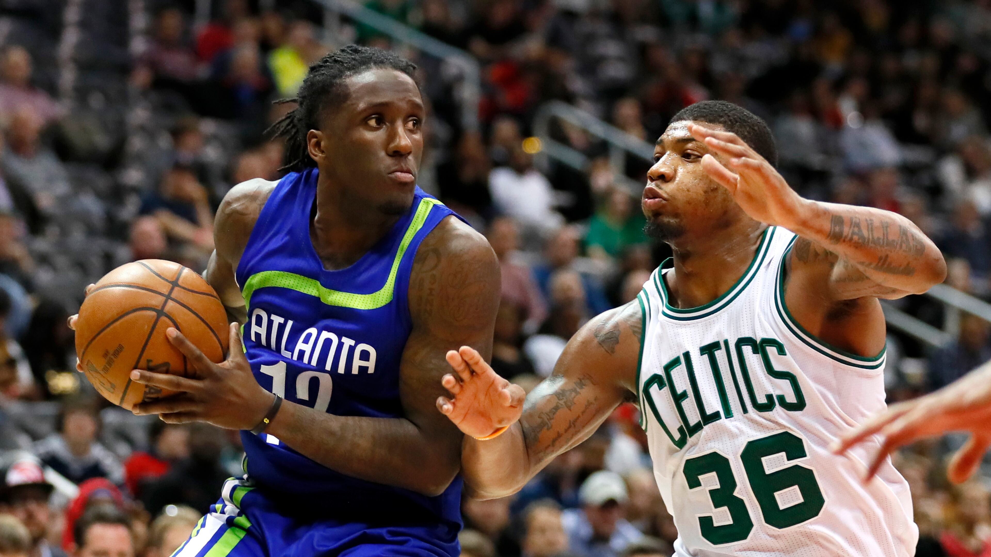 Atlanta Hawks forward Taurean Prince (12) looks to pass as Boston Celtics guard Marcus Smart (36) defends in the second half of an NBA basketball game on Thursday, April 6, 2017, in Atlanta. The Hawks won the game 123-116. (AP Photo/Todd Kirkland)